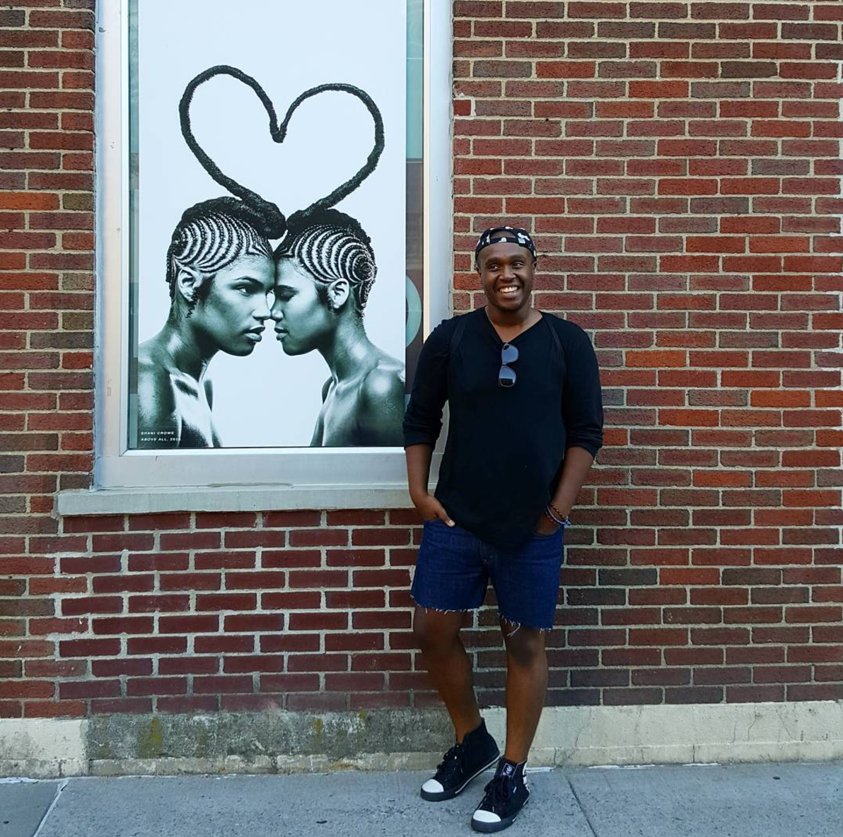 Standing next to a piece by Shani Crowe at MoCADA museum in Brooklyn, NY. Image by Lauren Van Slyke.