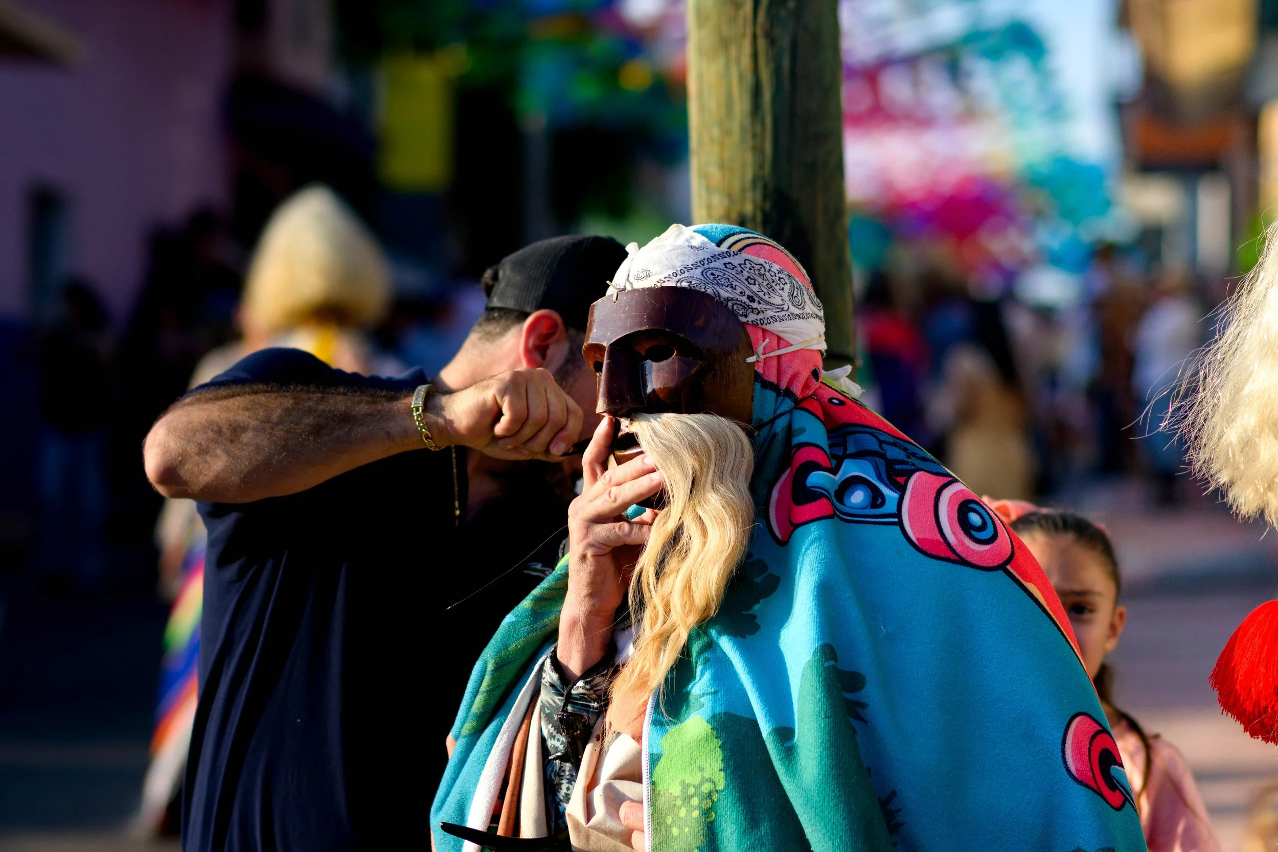 Helping a Tastuan with his mask.