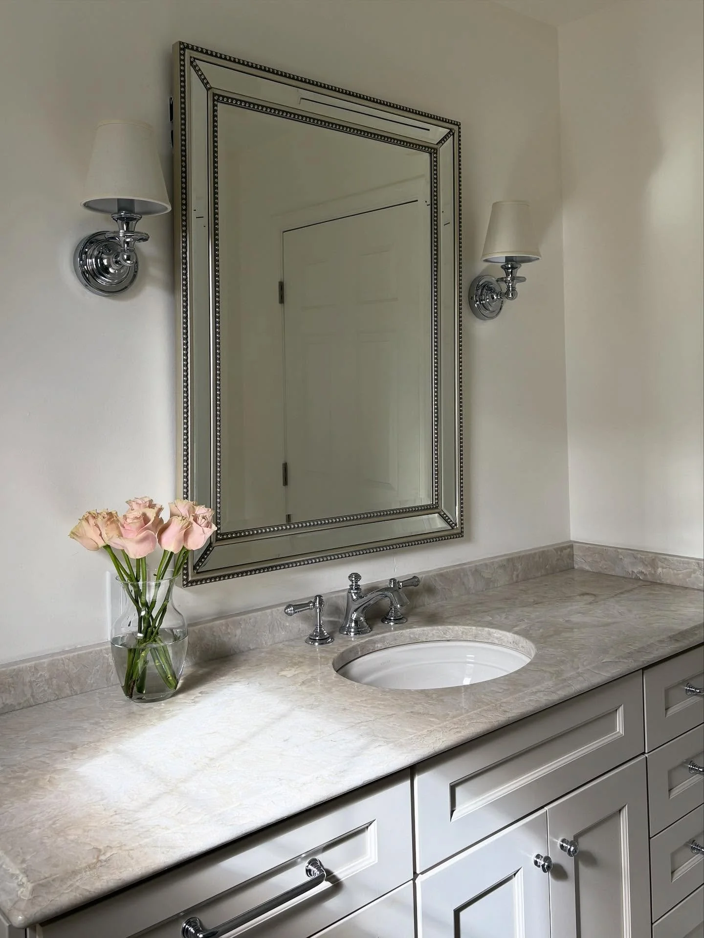 SQUEAKY CLEAN &bull; Transitional guest bathroom grounded in calming neutrals + punctuated with polished chrome hardware