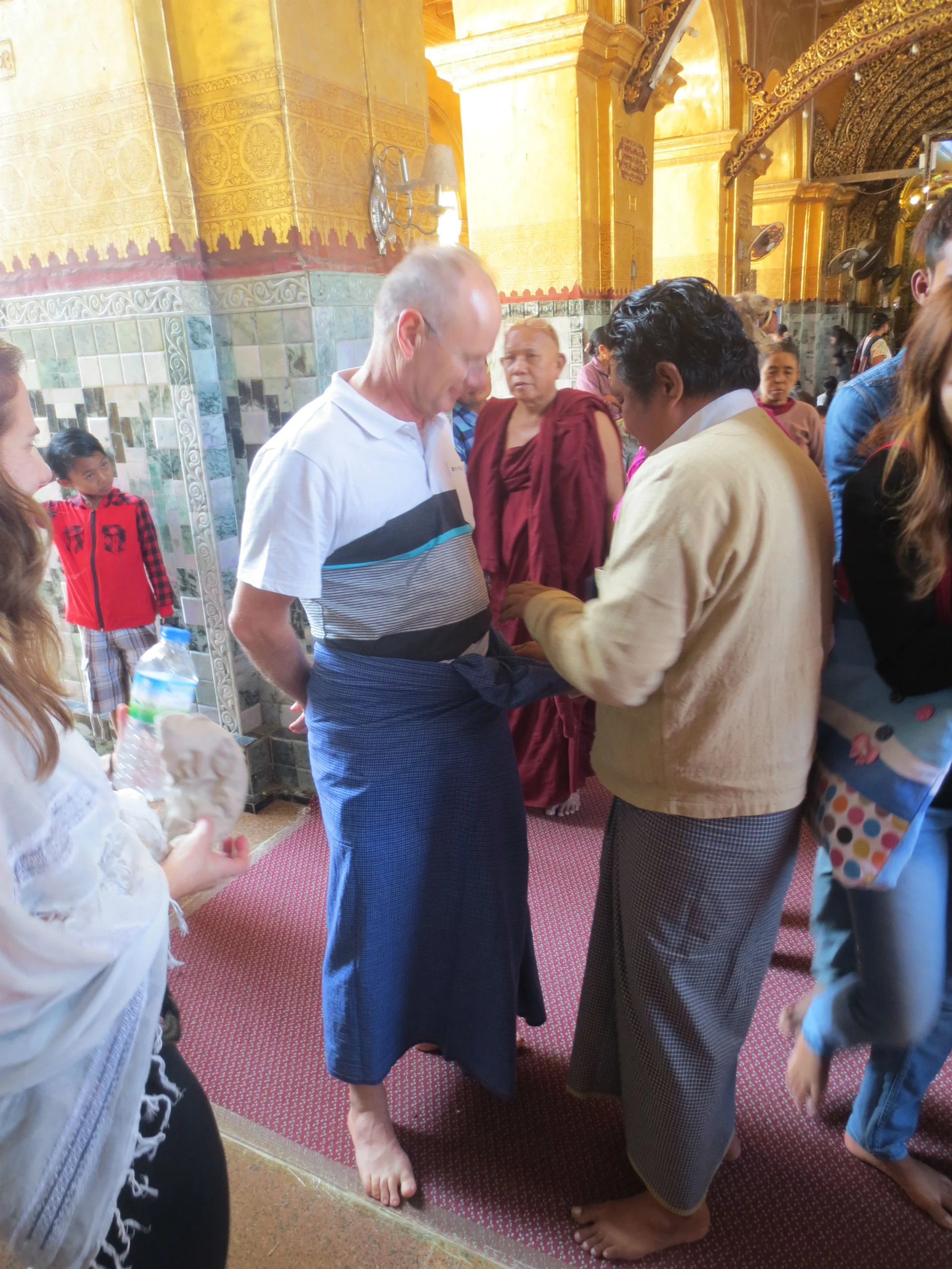 Fitting a Longyi before entering a temple