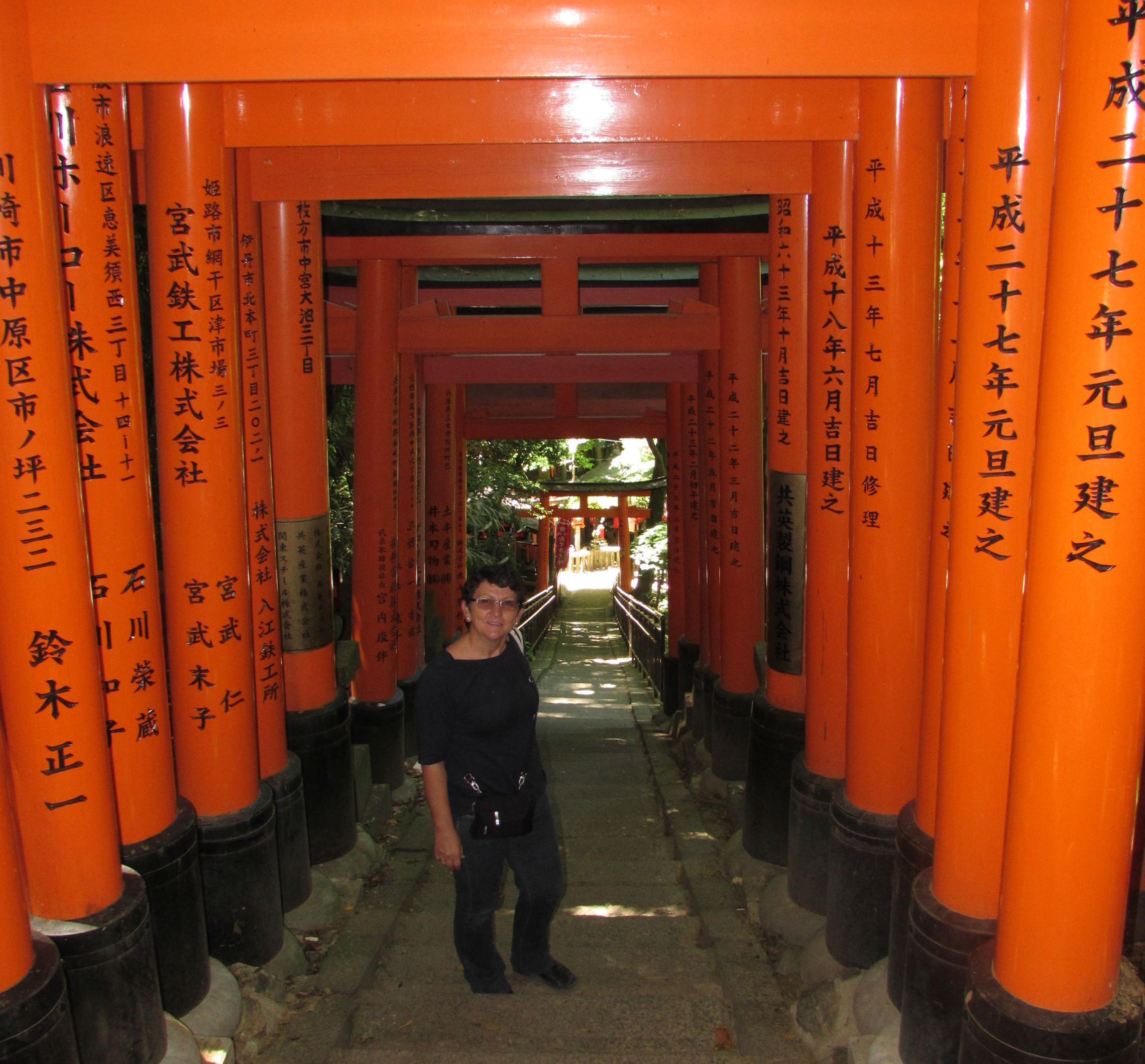 Walking underneath 1000 Torii's of the Fushimishi Inari shrine in Kyoto