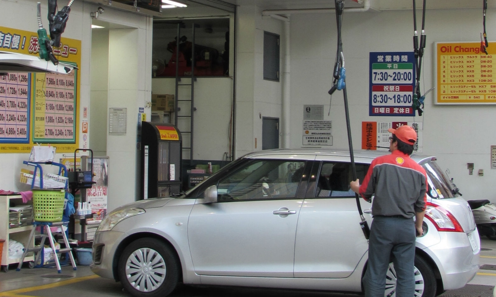 'Air born' filling nozzles at petrol station in Tokyo