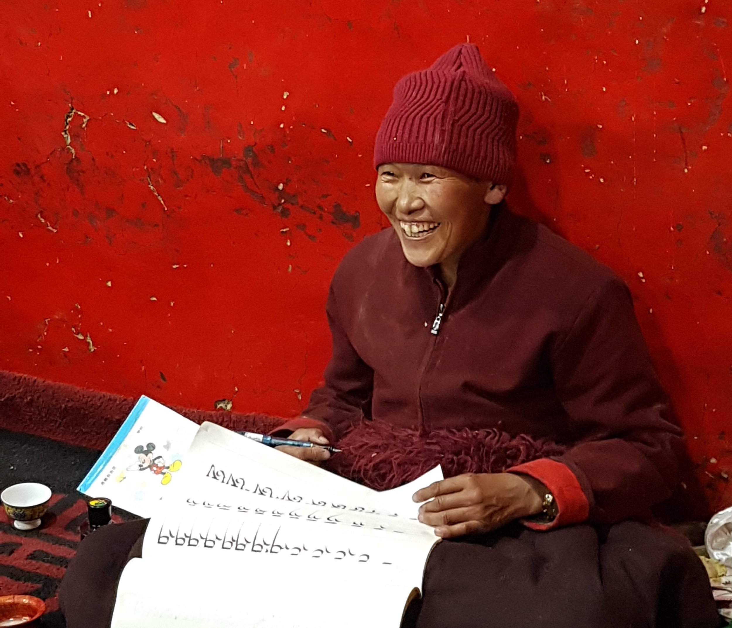 A nun practicing the ancient Tibetan scripture