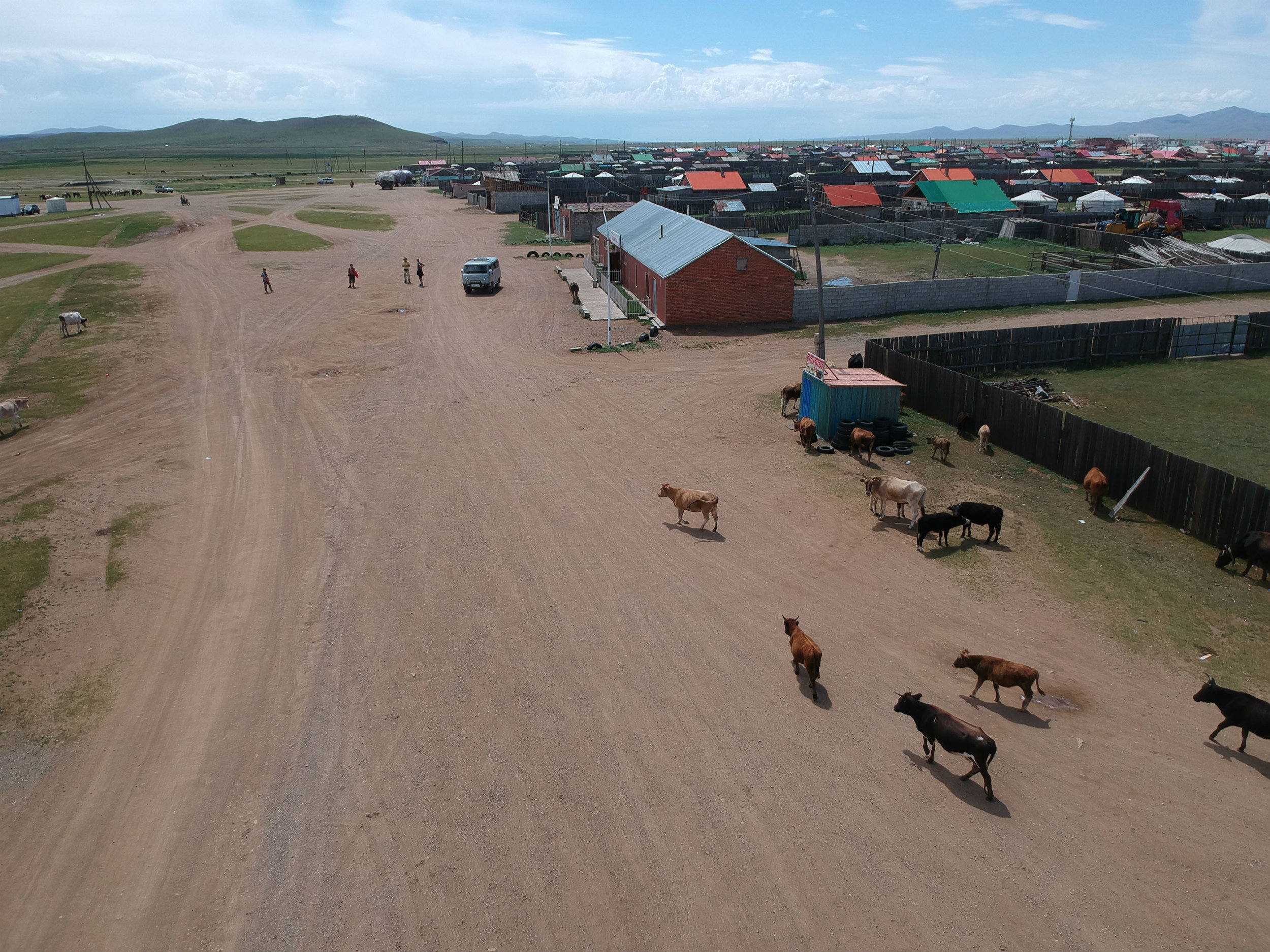 Lunch in Ulziik. Our van parked in front of eatery. Local children were afraid of my drone