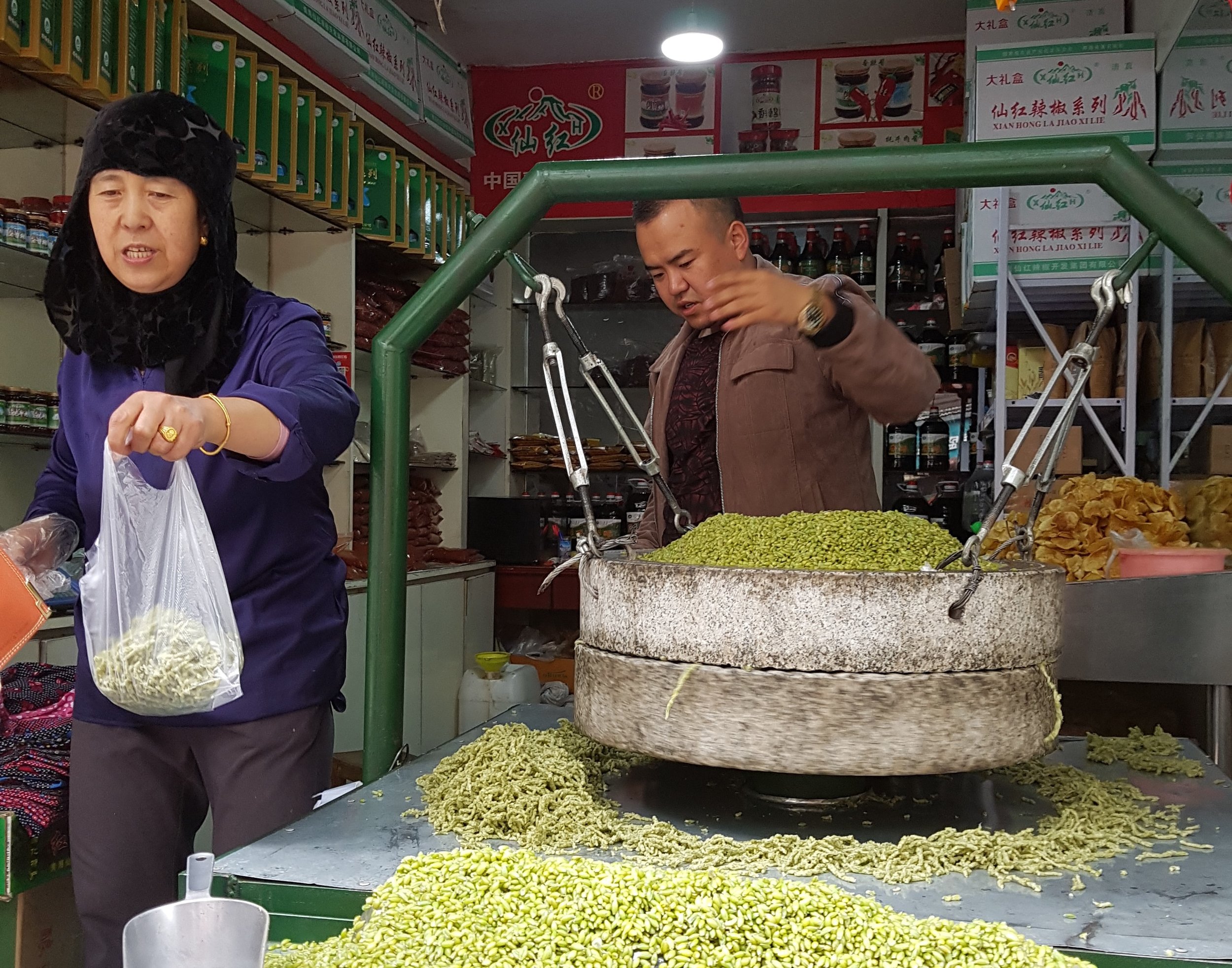 Selling grains in Xining - note typical black scarf of Hui woman