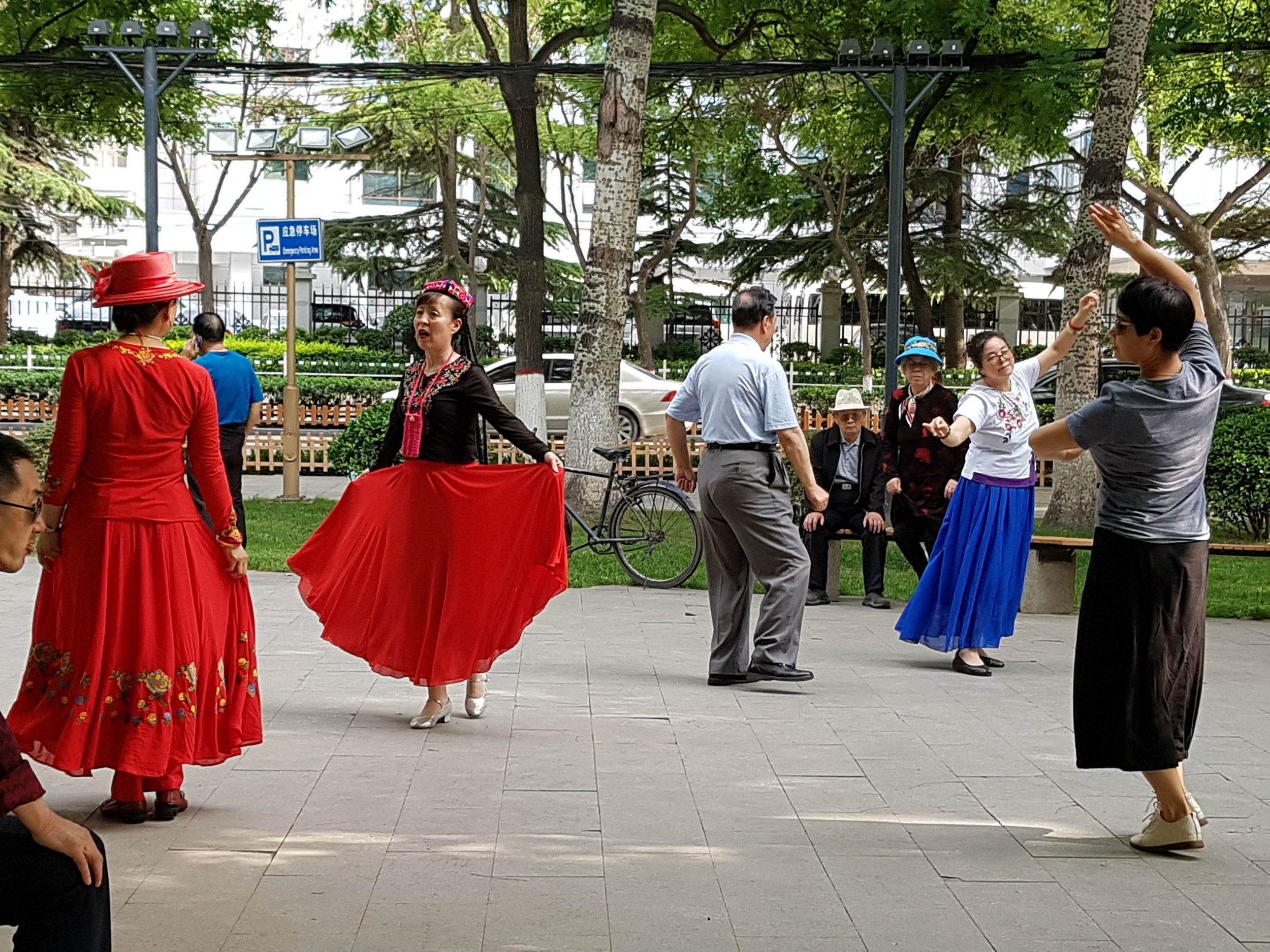 People singing and dancing in a park in Beijing