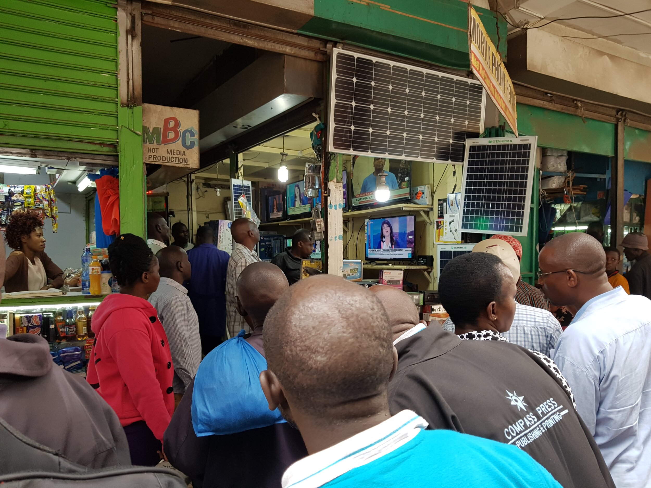 People viewing news broadcast about first COVID-19 case in Kenya (Copy)