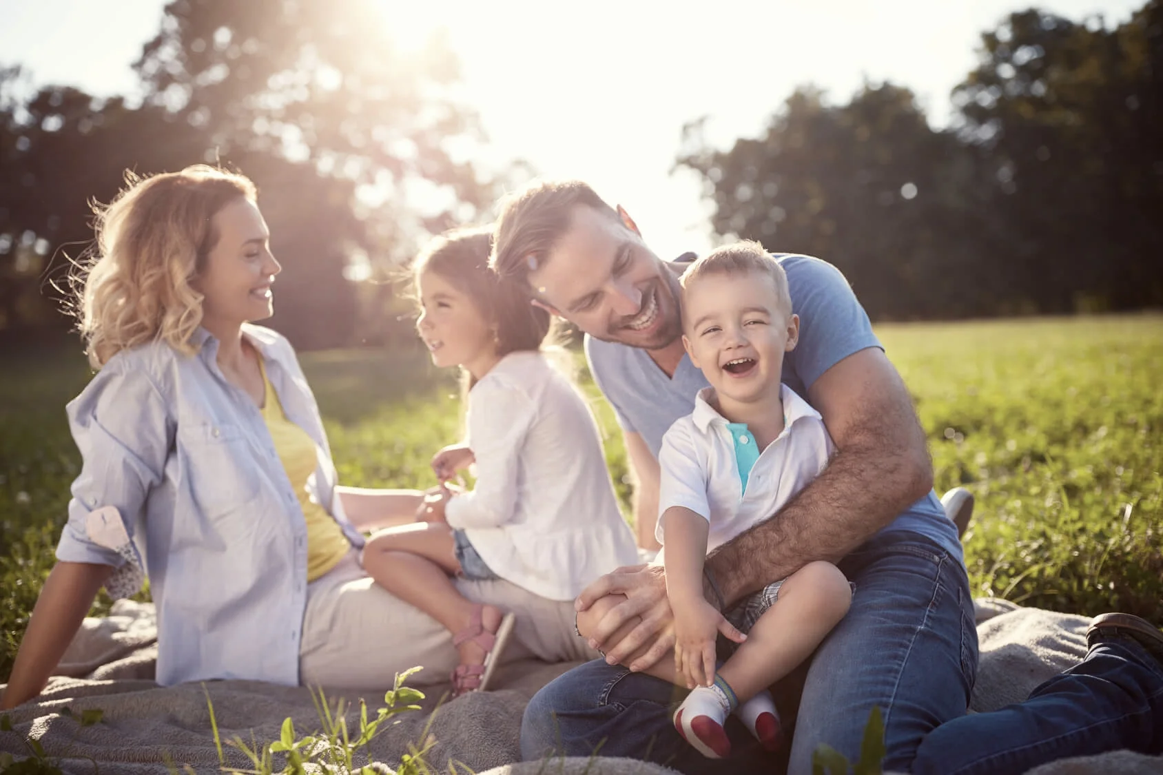 Happy young family enjoying a picnic following NHS dental treatment