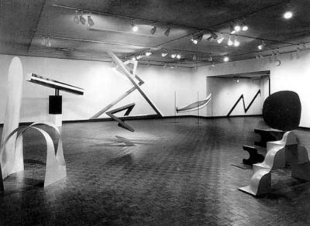 Installation view of Primary Structures: Younger American and British Sculptures at The Jewish Museum, 1966. Above: Kynaston McShine (center) at the opening of Primary Structures.
