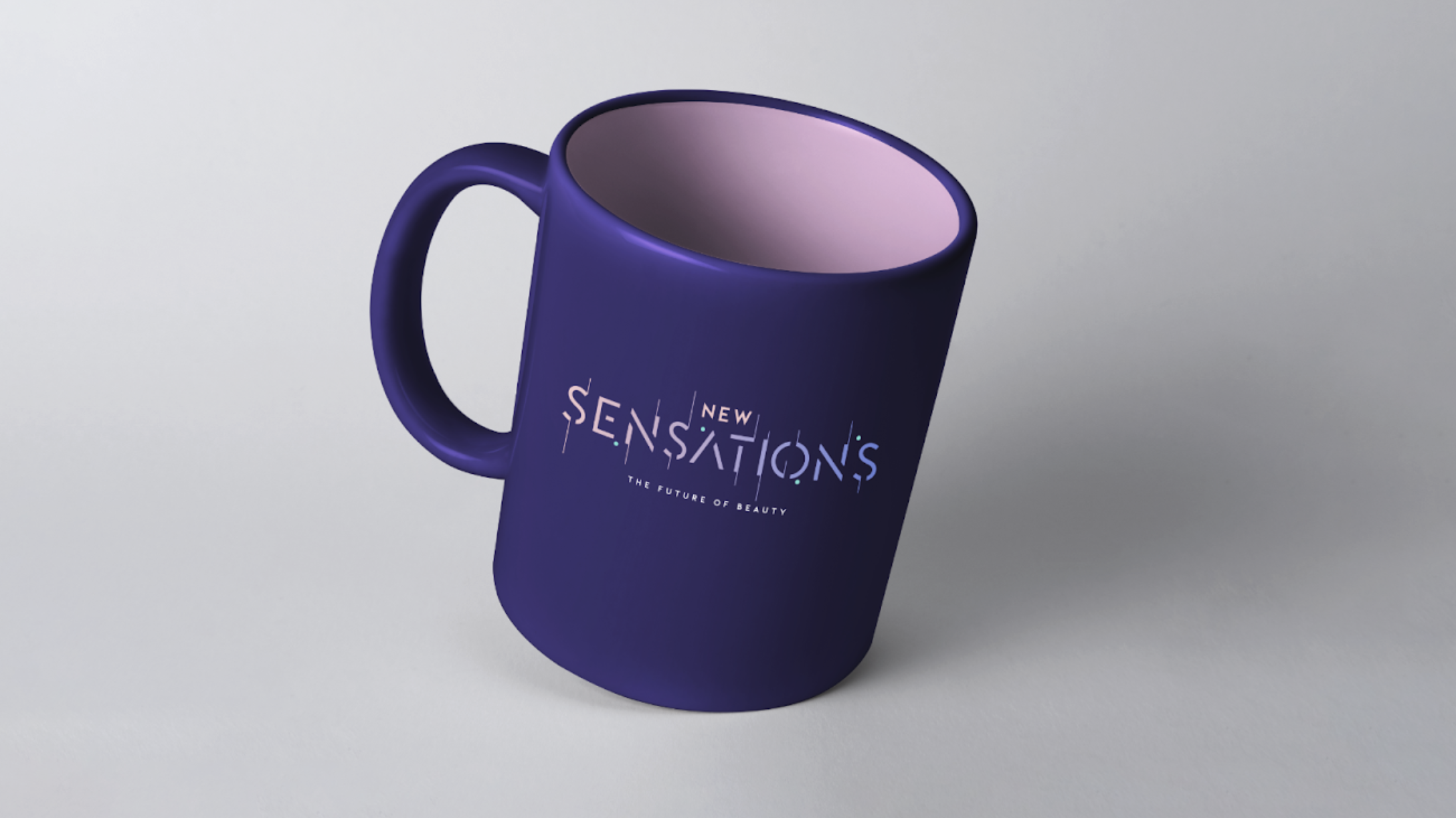 A purple ceramic mug with the words "New Sensations" and "The Future of Beauty" printed on it, placed on a light gray surface.