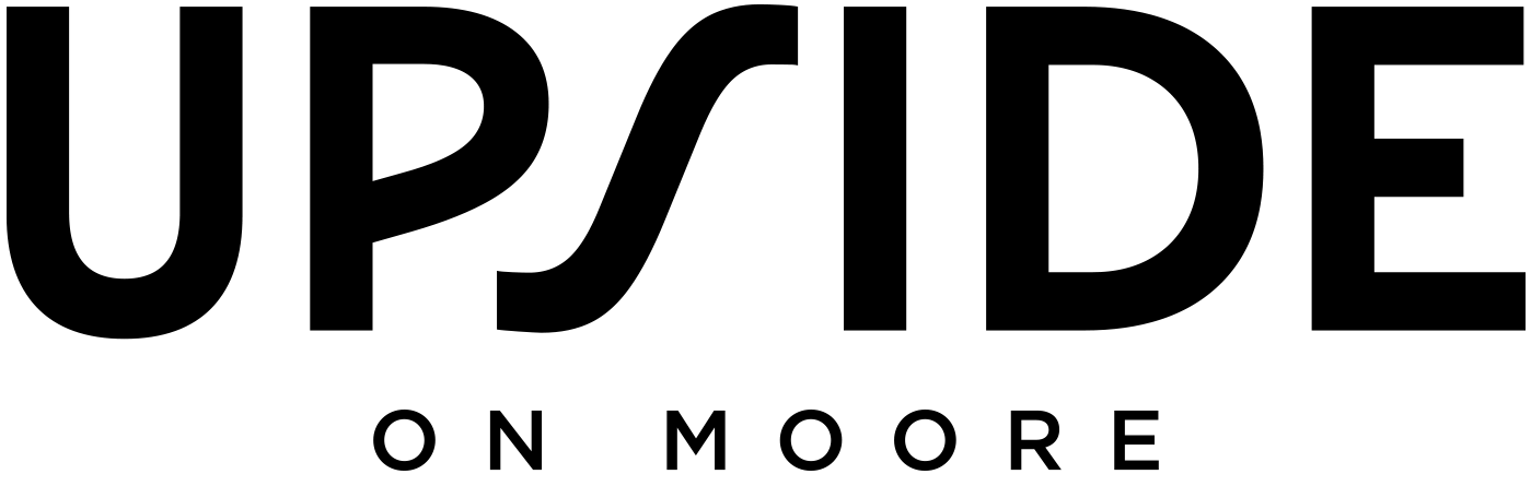 A blackboard with an adult reading a book to children in a classroom.