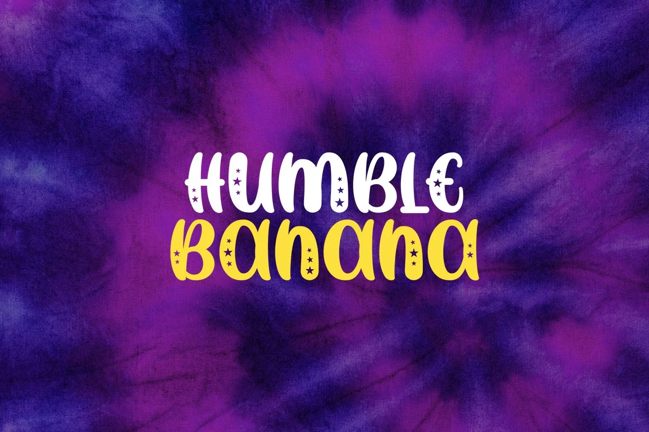 Colorful tie-dye background with the words 'Humble Banana' written in bold, playful font, with 'Humble' in white and 'Banana' in yellow, adorned with small star sparkles.