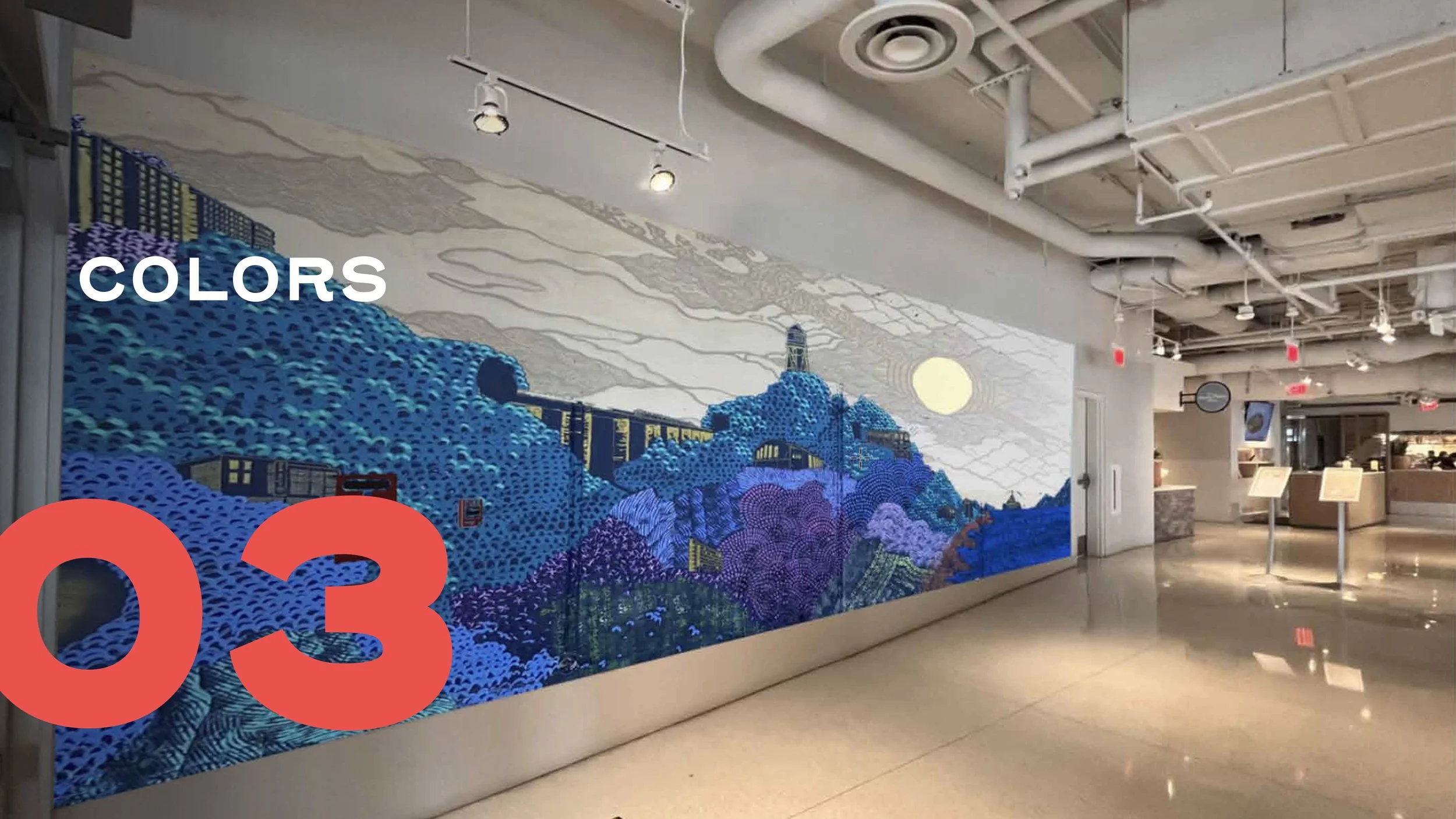 Colorful mural of a landscape scene with trees, hills, a bridge, and a large sun, on a wall inside a building with white ceiling and pipes.