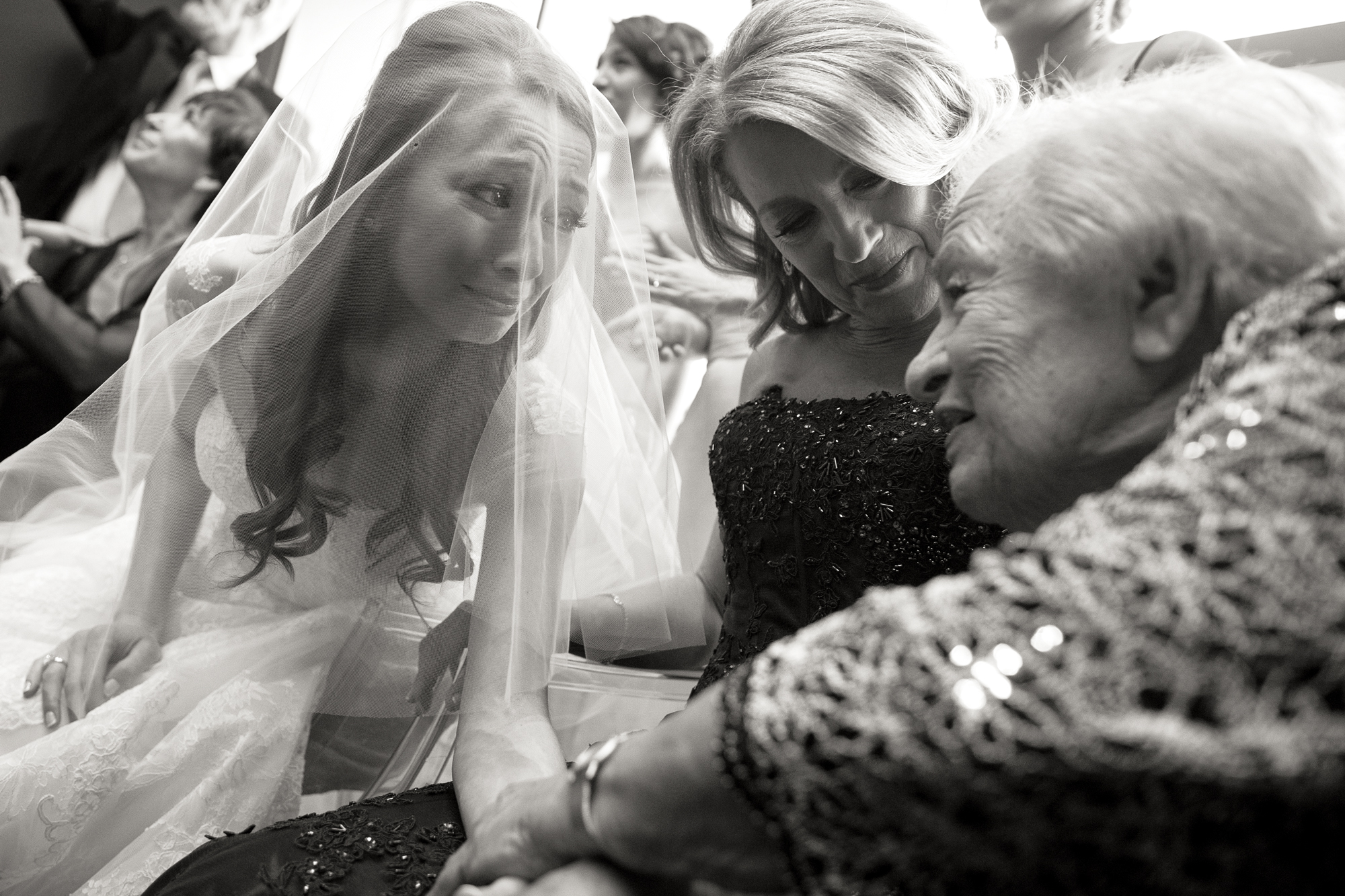 Melissa and her grandmother embrace during her bedekken ceremony with her mother in the middle. 