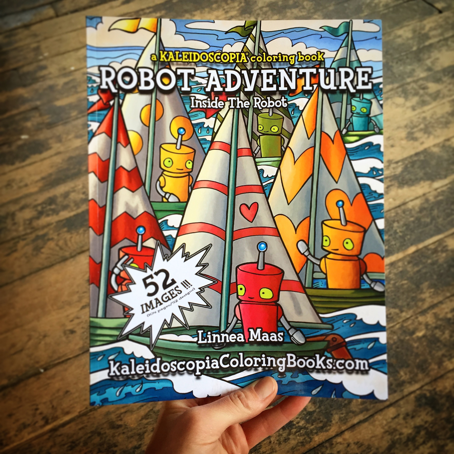 Hand holding a copy of Robot Adventure: Inside The Robot colorin