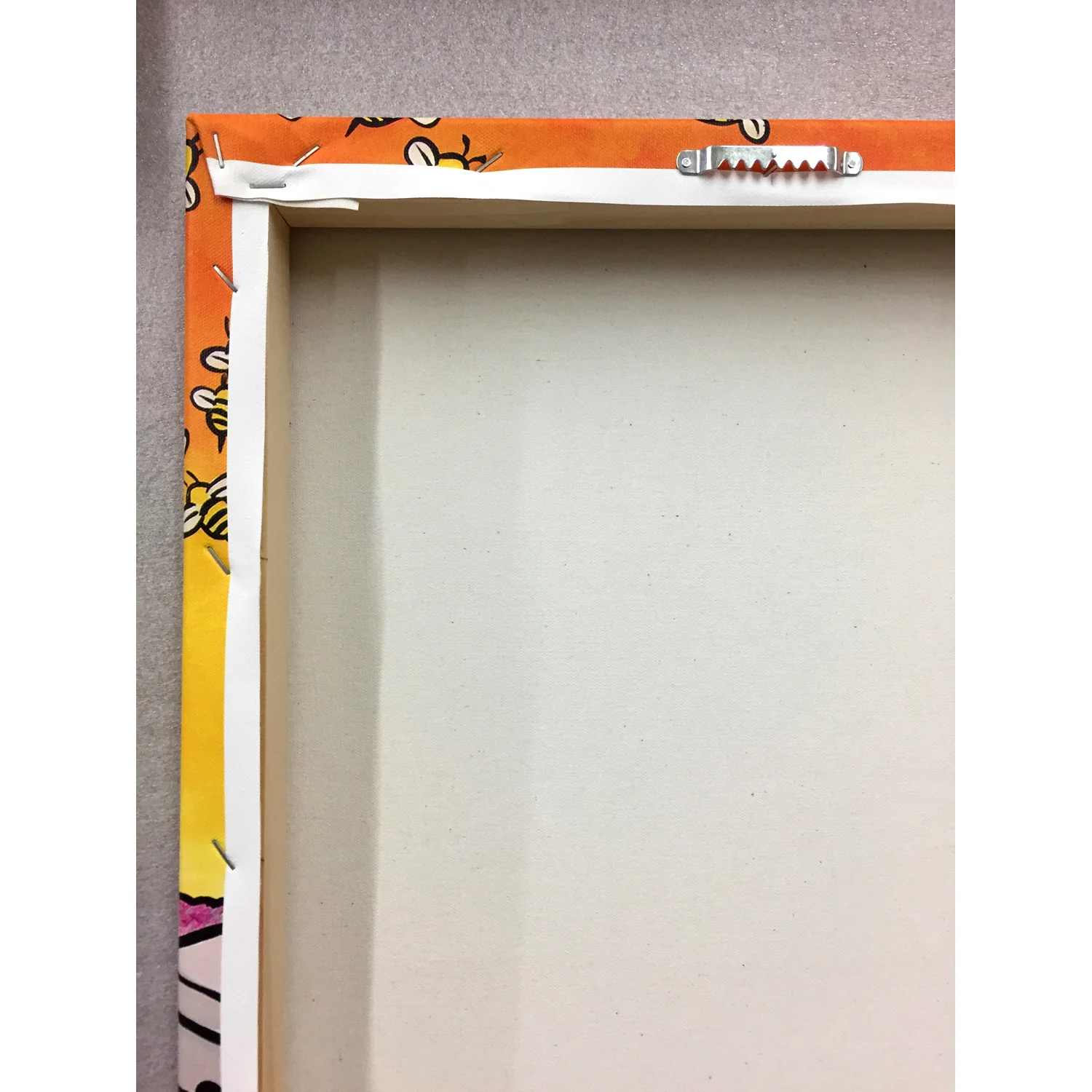 Sawtooth hanger on back of stretched canvas by Inside The Robot