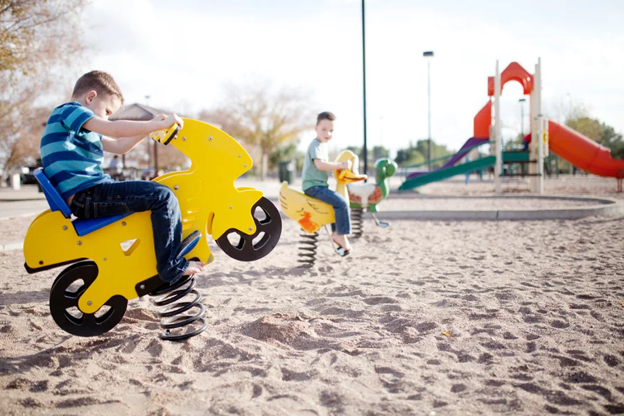 boys playing on toys at the playground