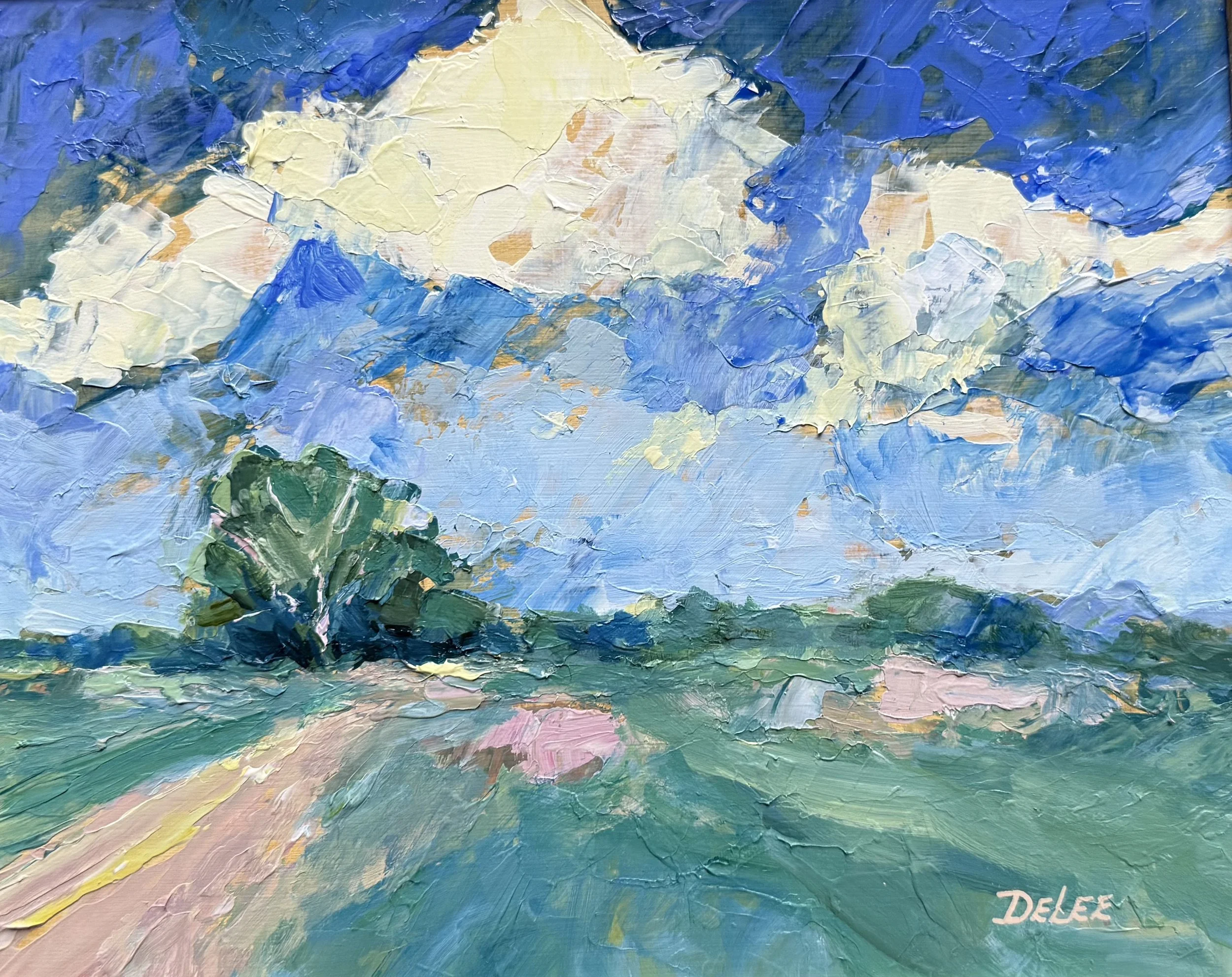 Prairie landscape beneath a dramatic blue sky with billowing clouds, painted by DeLee Grant