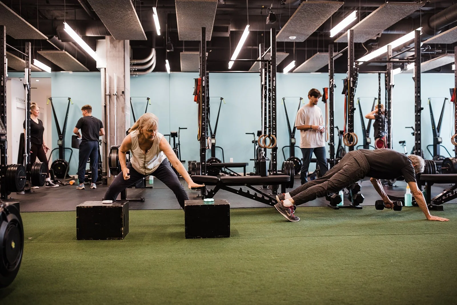 Middle aged female using reaction lights to improve agility in a gym setting