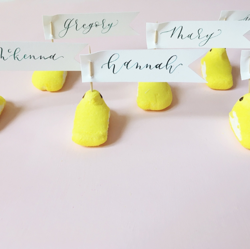 Okay, friends. This is a totally cute idea and actually super easy. Just cut strips of paper, write your guests' names and than use a toothpick to attach the name cards through the peeps! 