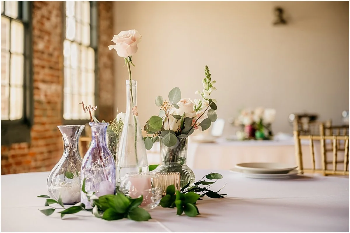 Wedding detail photo of one of the reception tables' centerpieces from a wedding photography session in Downtown Fredericksburg.