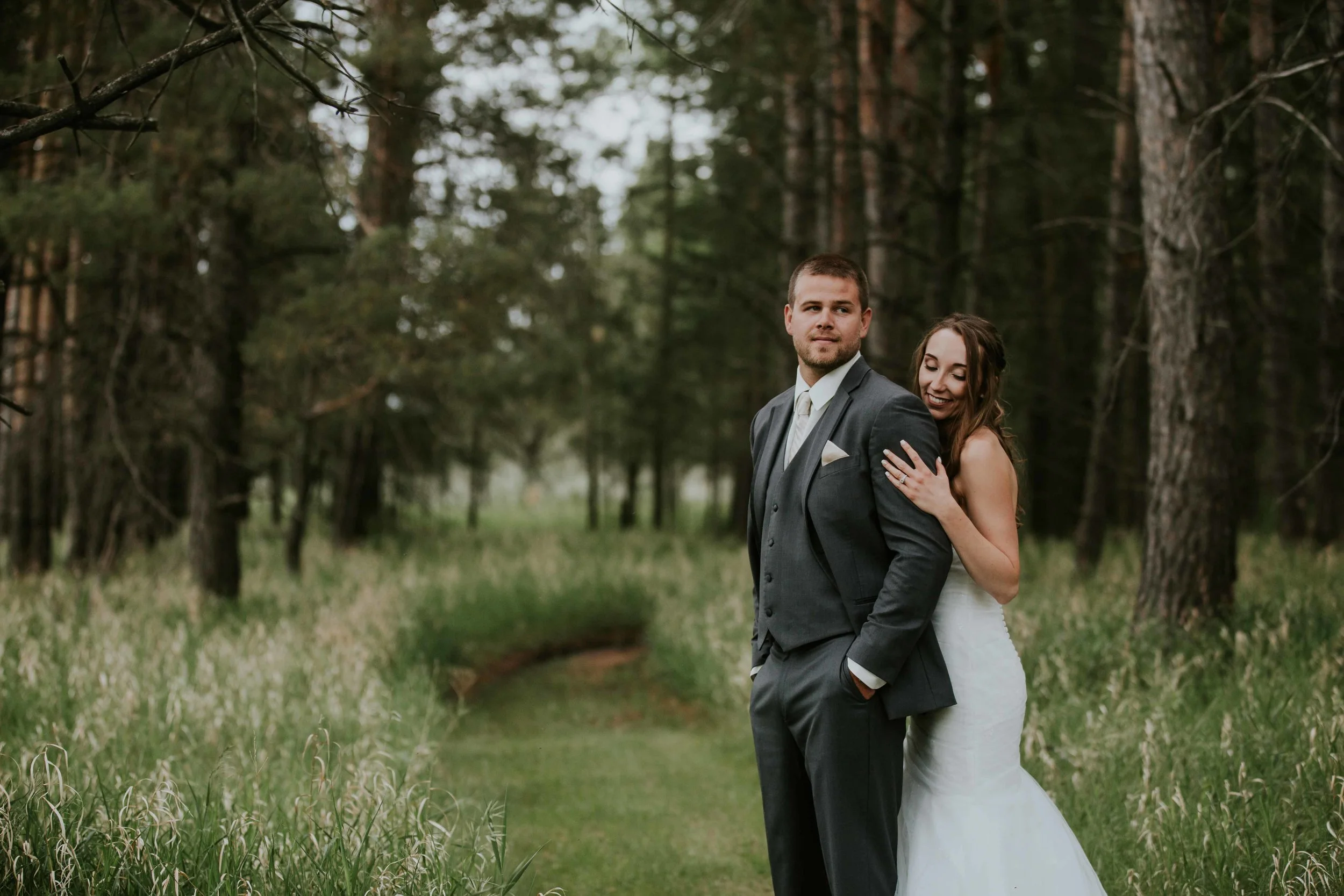 A little rain on your wedding day is meant to be a good omen, and if this rainy wedding photo shoot tells us anything, Tanner and Brooke have many great years ahead. The couple headed out into the woods after they said their “I Do’s” beneath an umbrella and towering trees with their homemade arch, right in their backyard. This day was absolutely perfect and the resulting images are dreamy.