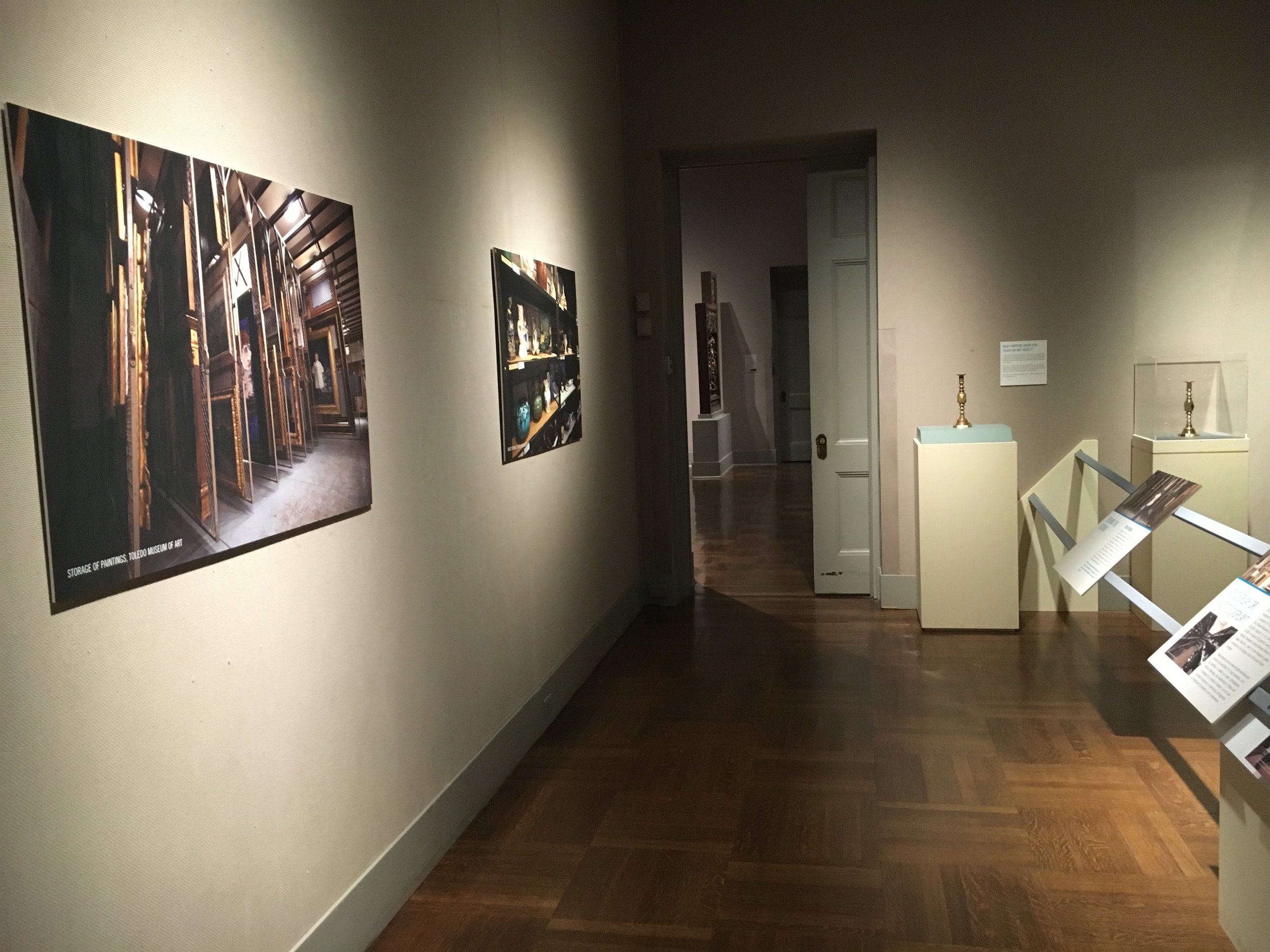 Passage way with images of museum storage on the left