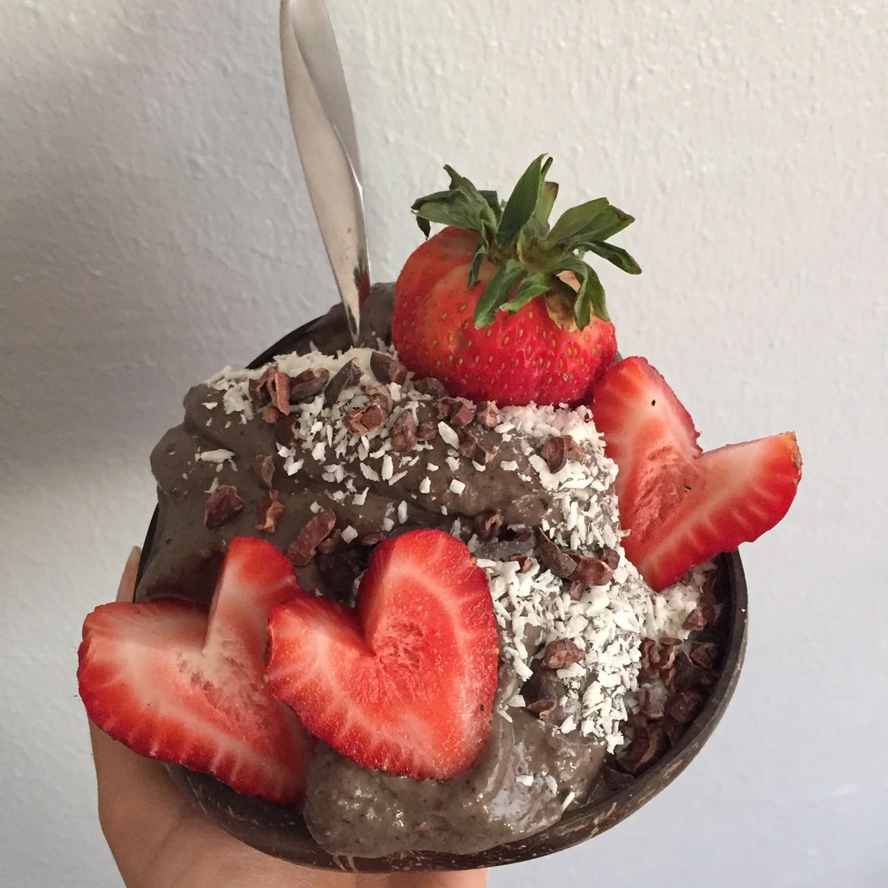Topped with coconut, cacao nibs and fresh strawberries