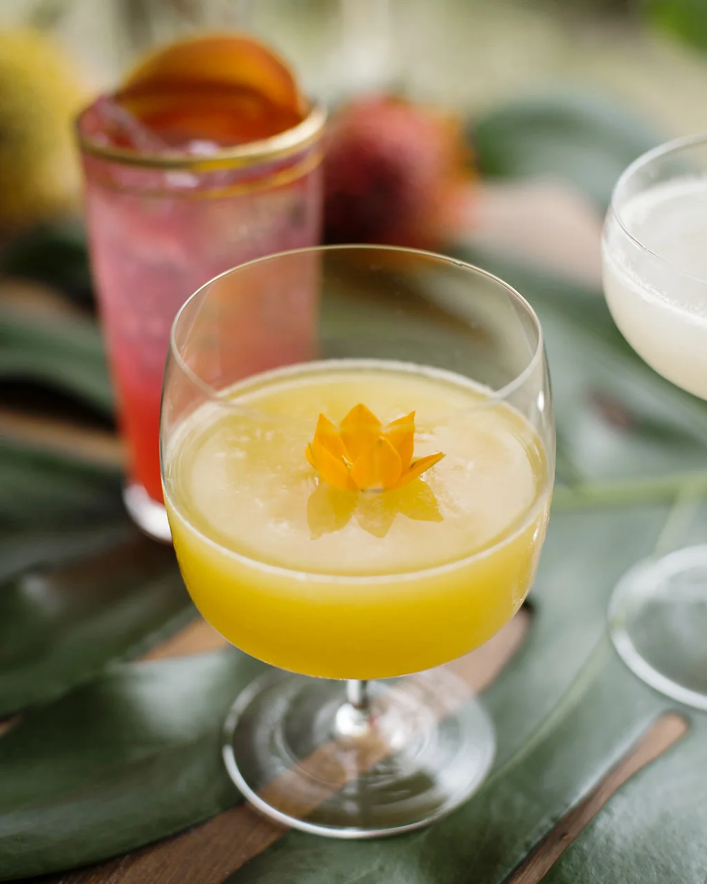 UNDER THE MANGO TREE fresh mango, lilikoi, coconut water, fresh pressed lime, golden and dark rums