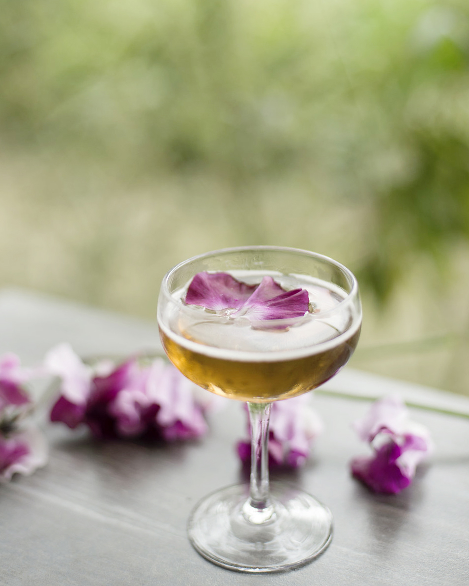 FIFTY SHADES OF GREY fresh pressed lemon, simple syrup, house grapefruit bitters, aged rum, violette liqueur rinse