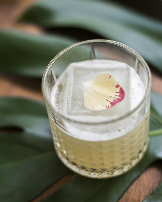 CAUGHT IN THE RAIN fresh pressed pineapple and lime, coconut water, aromatic bitters, coconut ice, golden rum