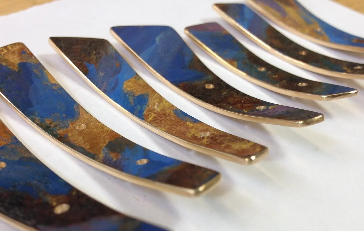Pigments and gold leaf on brass.