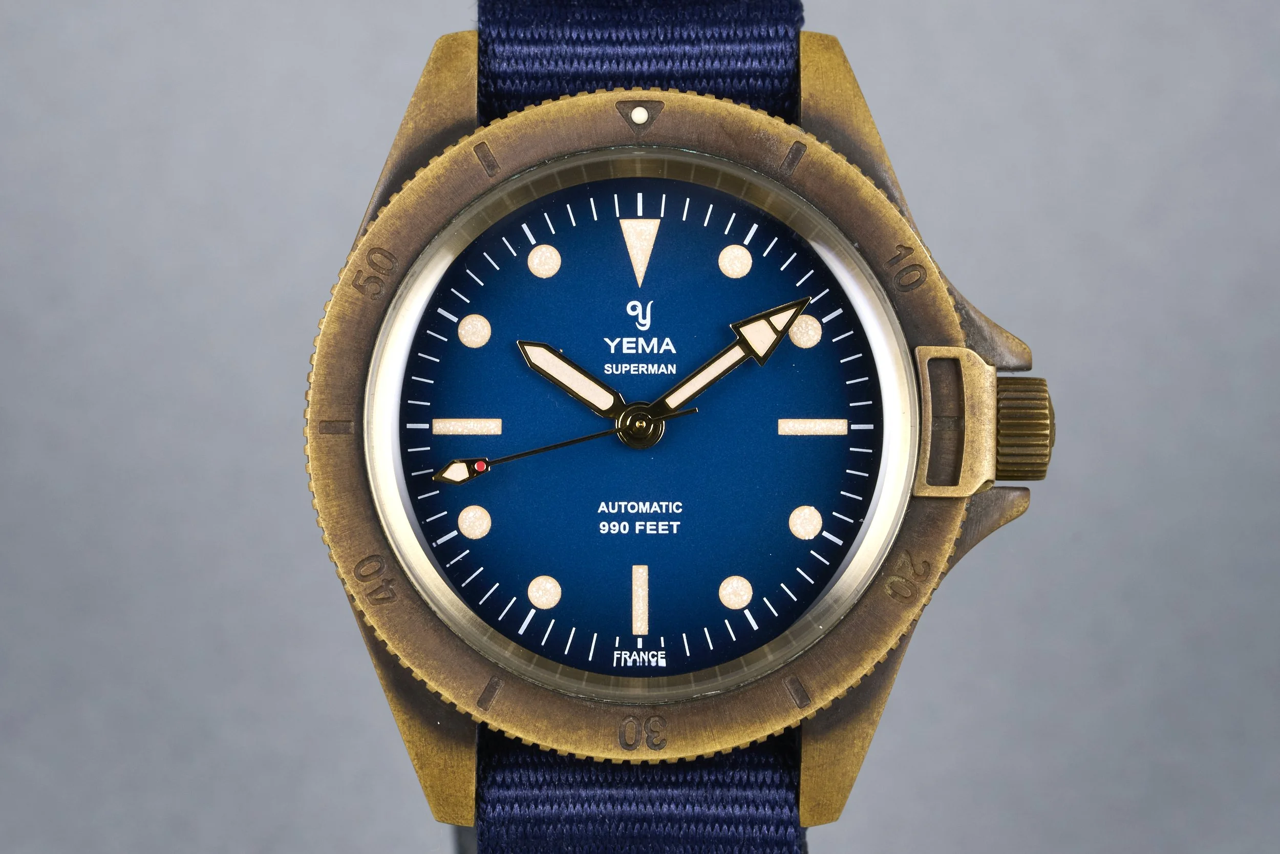 yema-superman.bronze.boxpapers-ysupz-blue.dial-2010-oysterpalace-OP2327-01.jpg