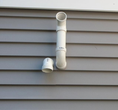 Intake and exhaust vents terminated on side of house.
