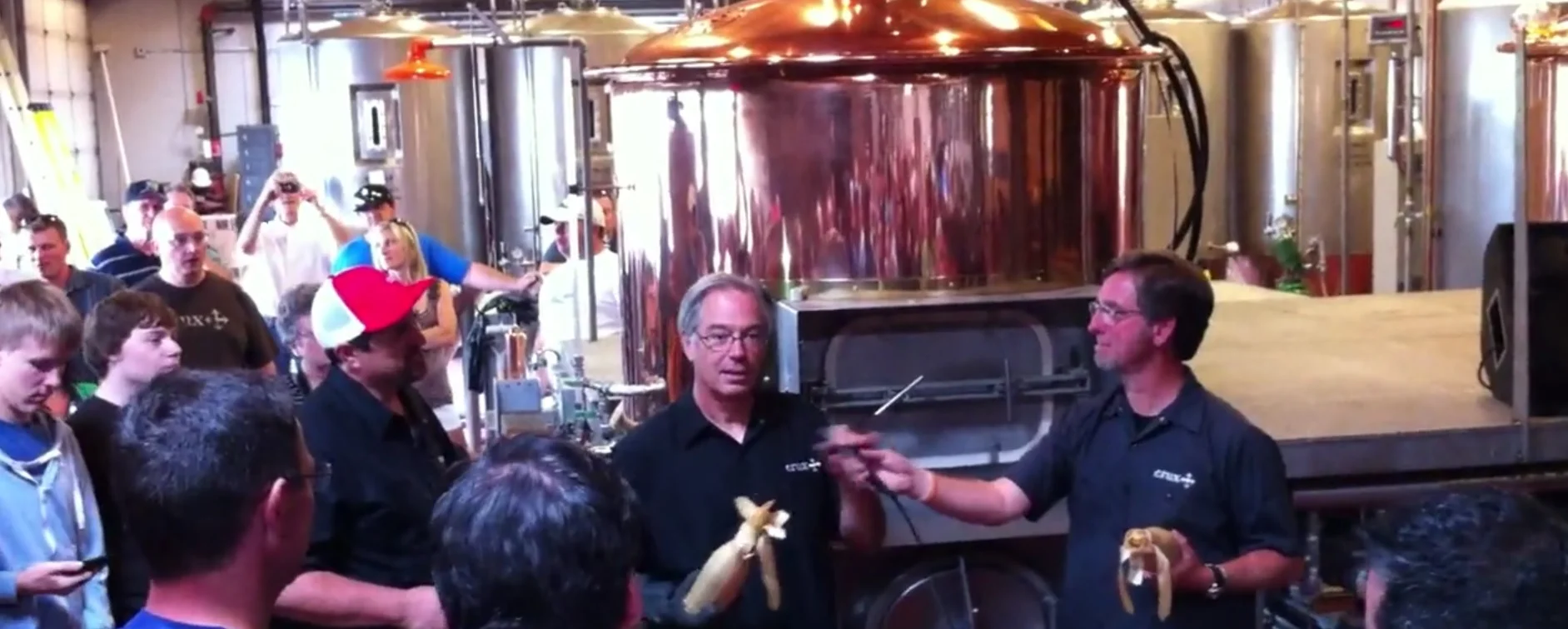 Larry Sidor (left) christening the new brewhouse at Crux Fermentation Project