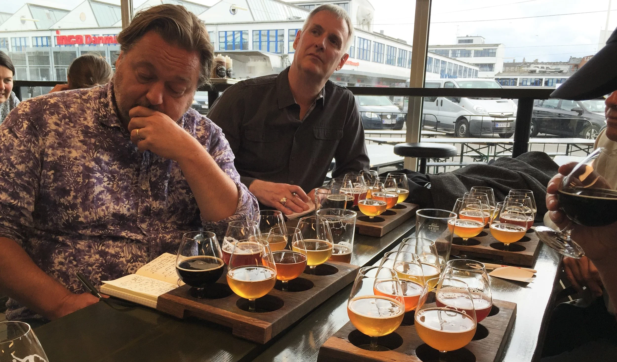 How are these men describing their beers?