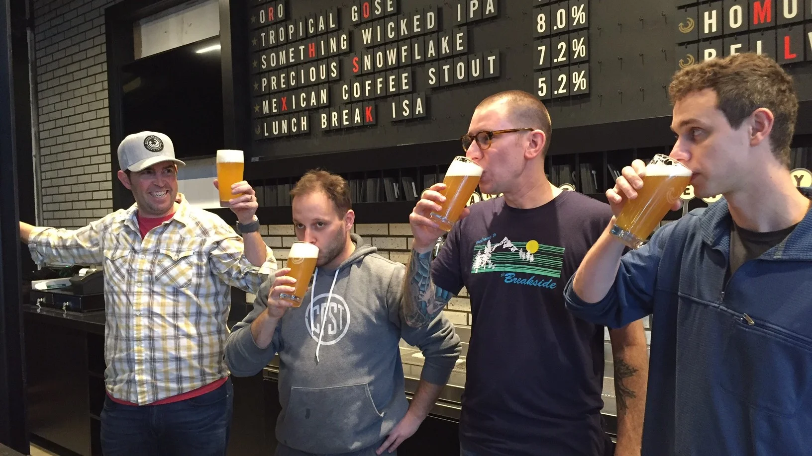 The men from Breakside drinking the first pints at the new Slabtown brewery and pub.