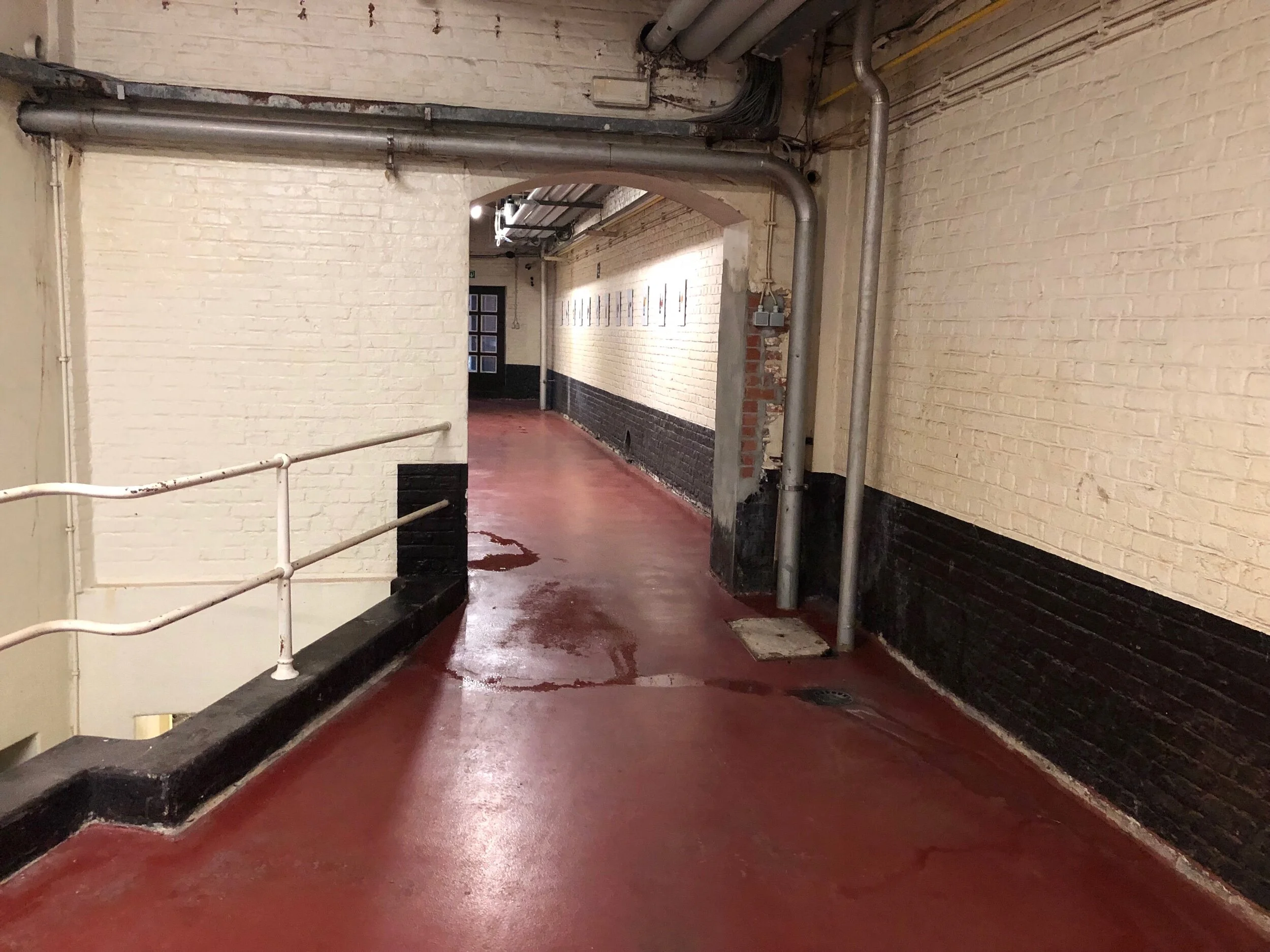 The entire brewery was scrubbed and neat as a pin—even this passageway between the brewhouse and cellars had recently been mopped.