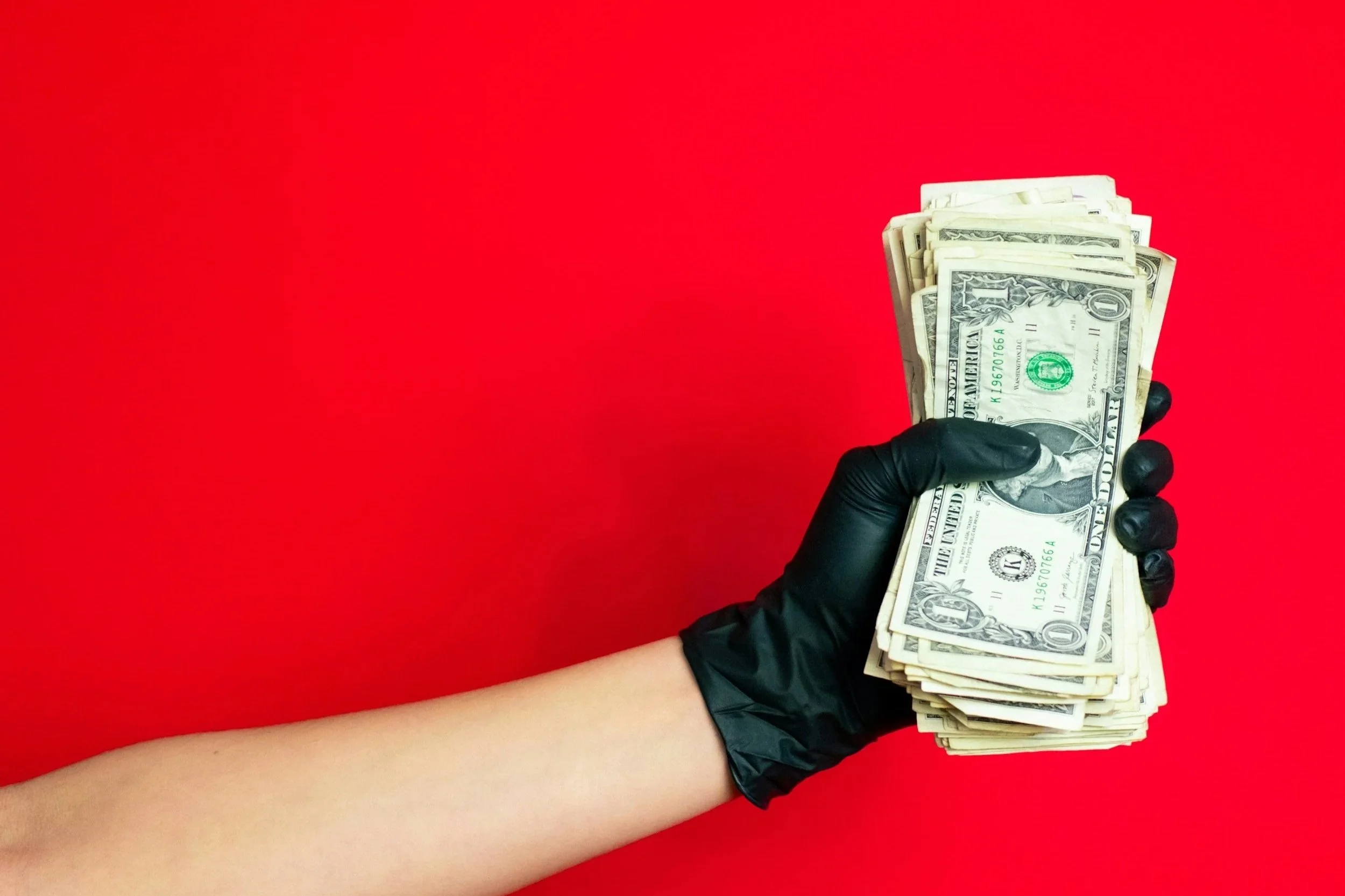 Colorful hot air balloons floating in a clear blue sky, with one large striped balloon dominating the foreground and several smaller balloons in the background.