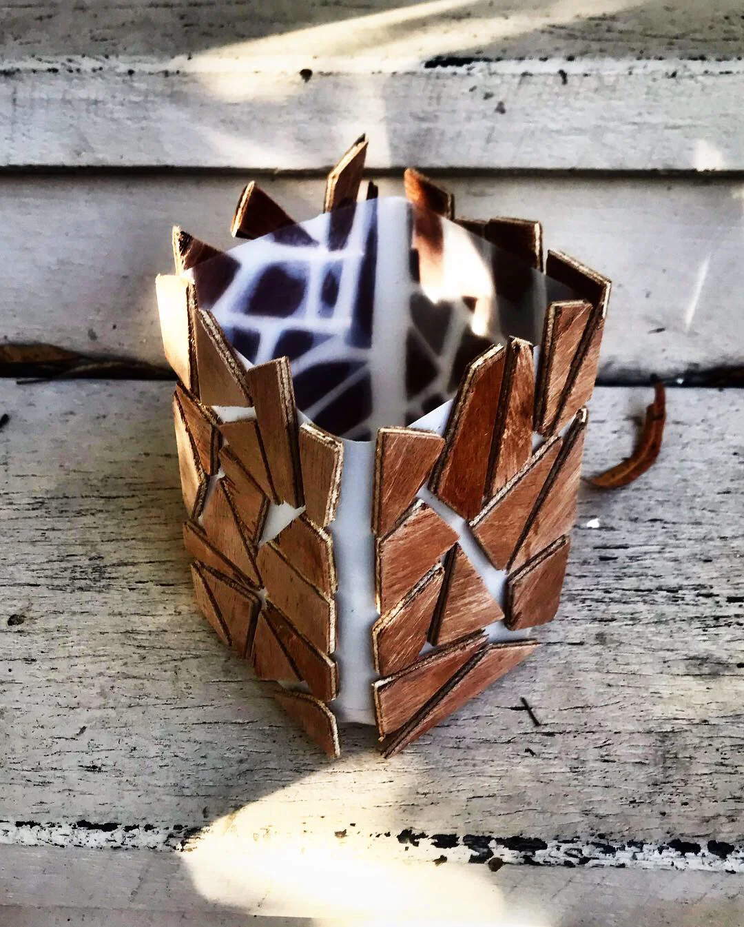Parchet Plywood mosaic on plastic milk bottle 2019 Parquet is a geometric mosaic of wood pieces used for decorative effect, mostly in flooring. The word derives from the Old French word parchet (the diminutive of parc), literally meaning "a small enclosed space"