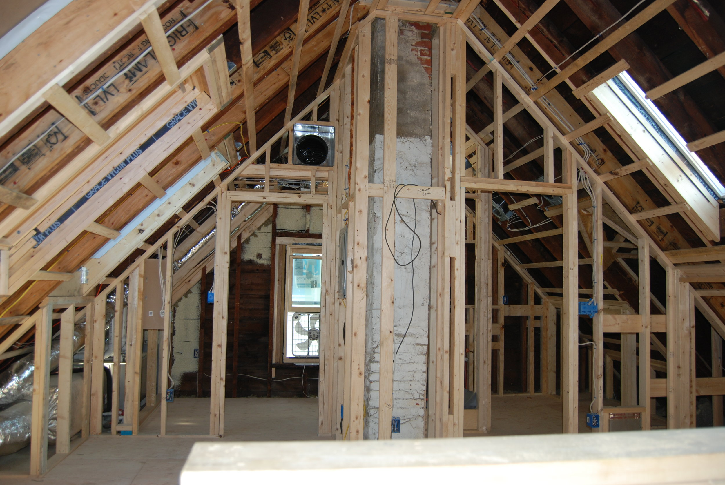 Here is a great example of the hot roof method in action. It has been used to successfully insulate and air seal in an attached single family home renovation several years ago. We gutted the entire attic and installed spray foam insulation along the top of the lower walls, and directly on the underside of the roof. We also sprayed the very bottom of the walls around the perimeter of the basement right along the rim joist. This effectively blocked the air flowing into the walls and floor from the basement and rising all the way up to the attic.