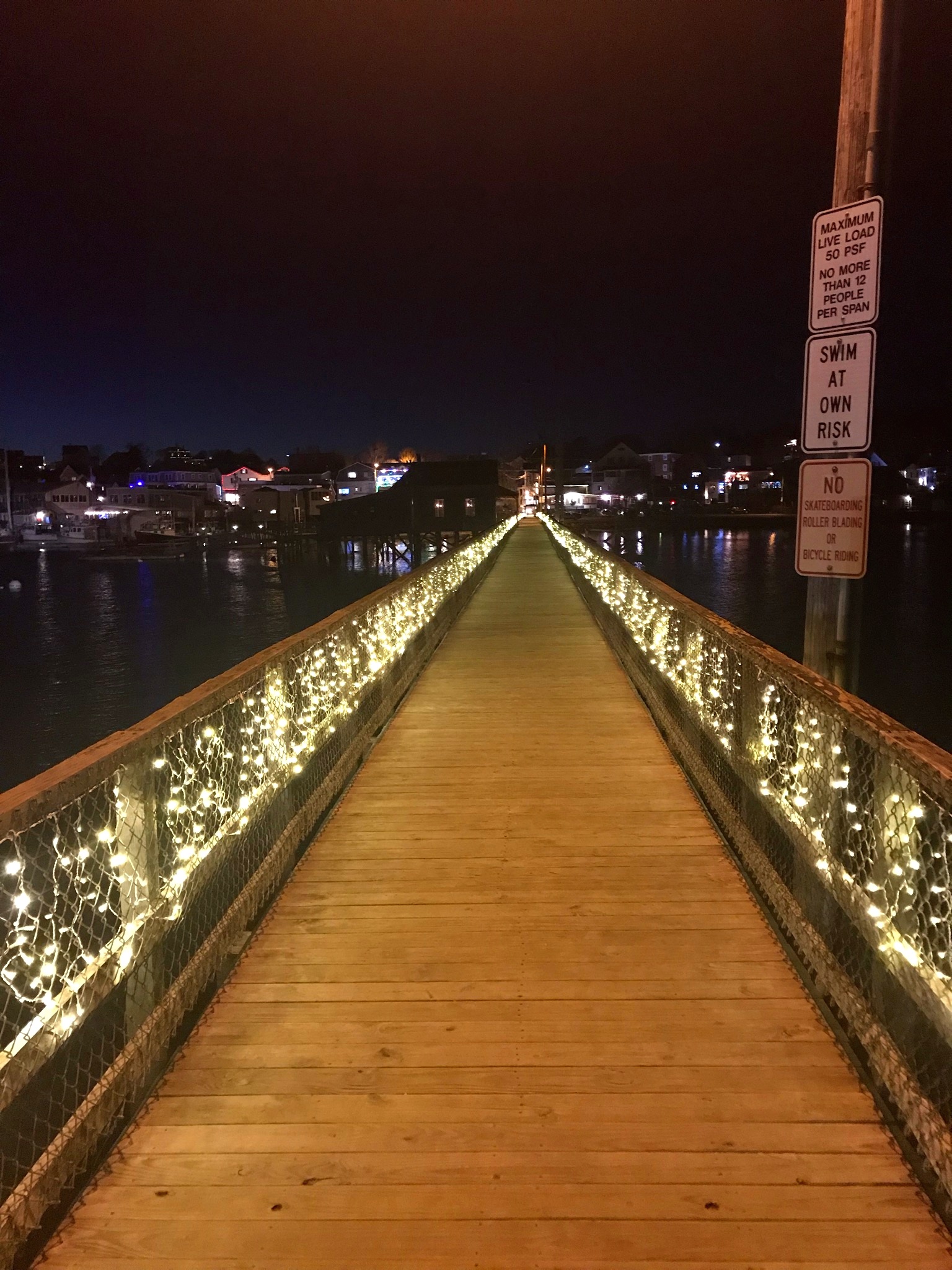 The beautifully lit path of the footbridge