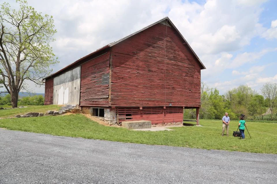John Adamson of the Shenandoah County Historical Society being interviewed by WHSV-TV of Harrisonburg, VA. This is the barn at Fairview Park in Woodstock.