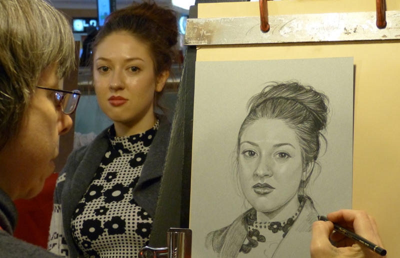 Rita Kirkman was born an artist. She was drawing portraits of friends and family members by the age of 11, and had her first paid portrait commission at 17. While still in school, she began a 12 year career sketching quick portraits at amusement parks. “Hey, I can draw you in five minutes!” was a frequently heard catchphrase from the portrait stand at Cedar Point. The competitive atmosphere among the artists had the ambitious ones cranking out a portrait in well under 5 minutes. “I think my record was 2 minutes and 45 seconds!” laughs Kirkman. These days Rita does the same quick portraits and caricatures at the San Antonio Rodeo each February and at Rolling Oaks Mall in San Antonio at Christmastime. But there's more to this artist than quick-sketching... Since retiring from amusement parks in 1997, Kirkman has expanded her business of quality hand-drawn pencil portraits, which she began in 1988. Today she has hundreds of satisfied clients all around the world, including Canada, Japan, Australia, Europe, Mexico, and of course the USA. You can also see Kirkman's award-winning pastel paintings and portraits at RitaKirkman.com , and her Daily Paintings on her blog at ritakirkman.blogspot.com .