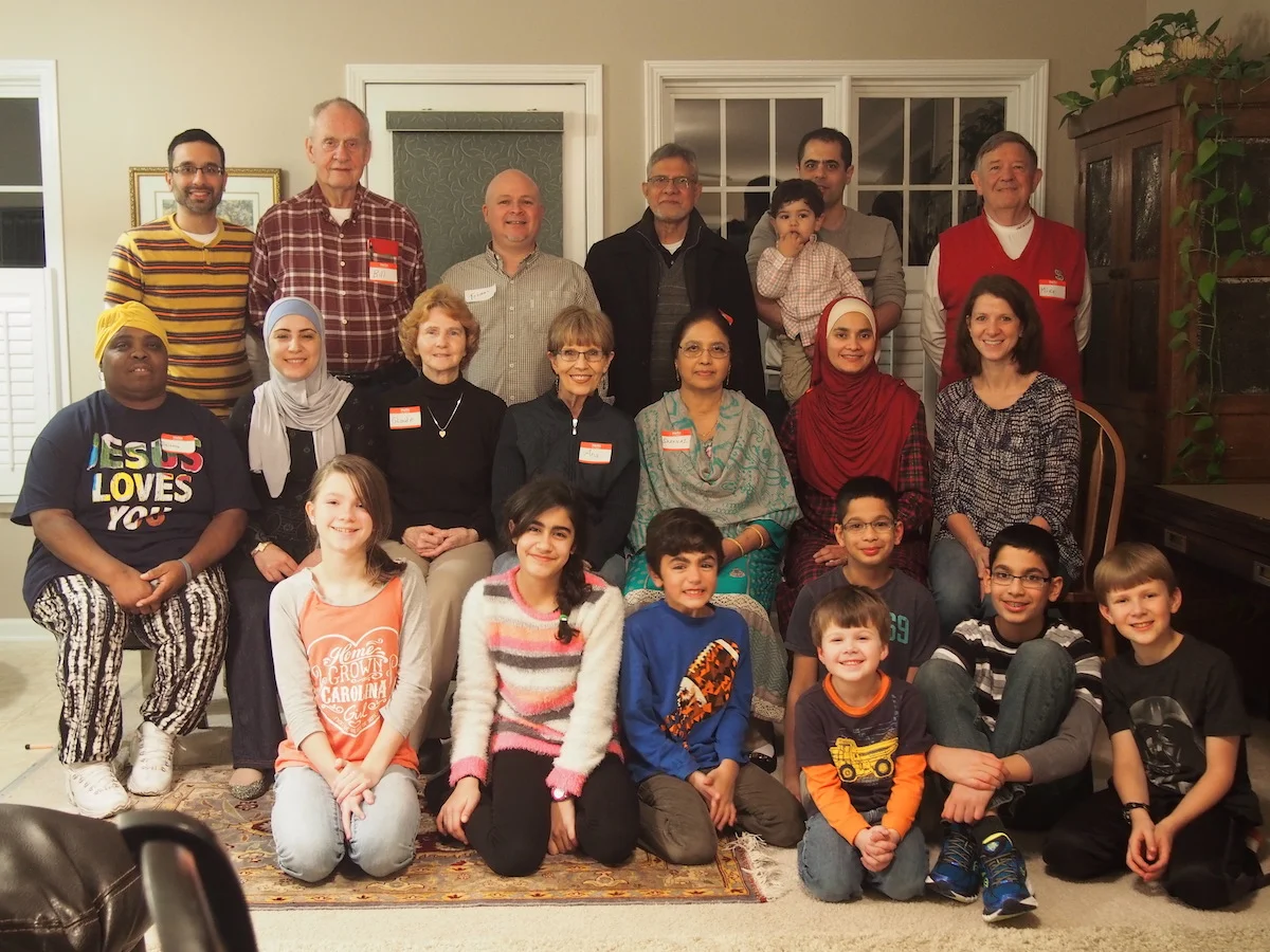 A recent gathering, in the Davis home, of the Apex Mosque/Fellowship of Christ Dinner Club. We gather monthly for a halal (permissible for Muslims) potluck meal, lots of laughter and friendship-building, and occasional serious talk as well. At present, we are exploring ways we can work together as Muslims and Christians to serve refugees moving into our area.