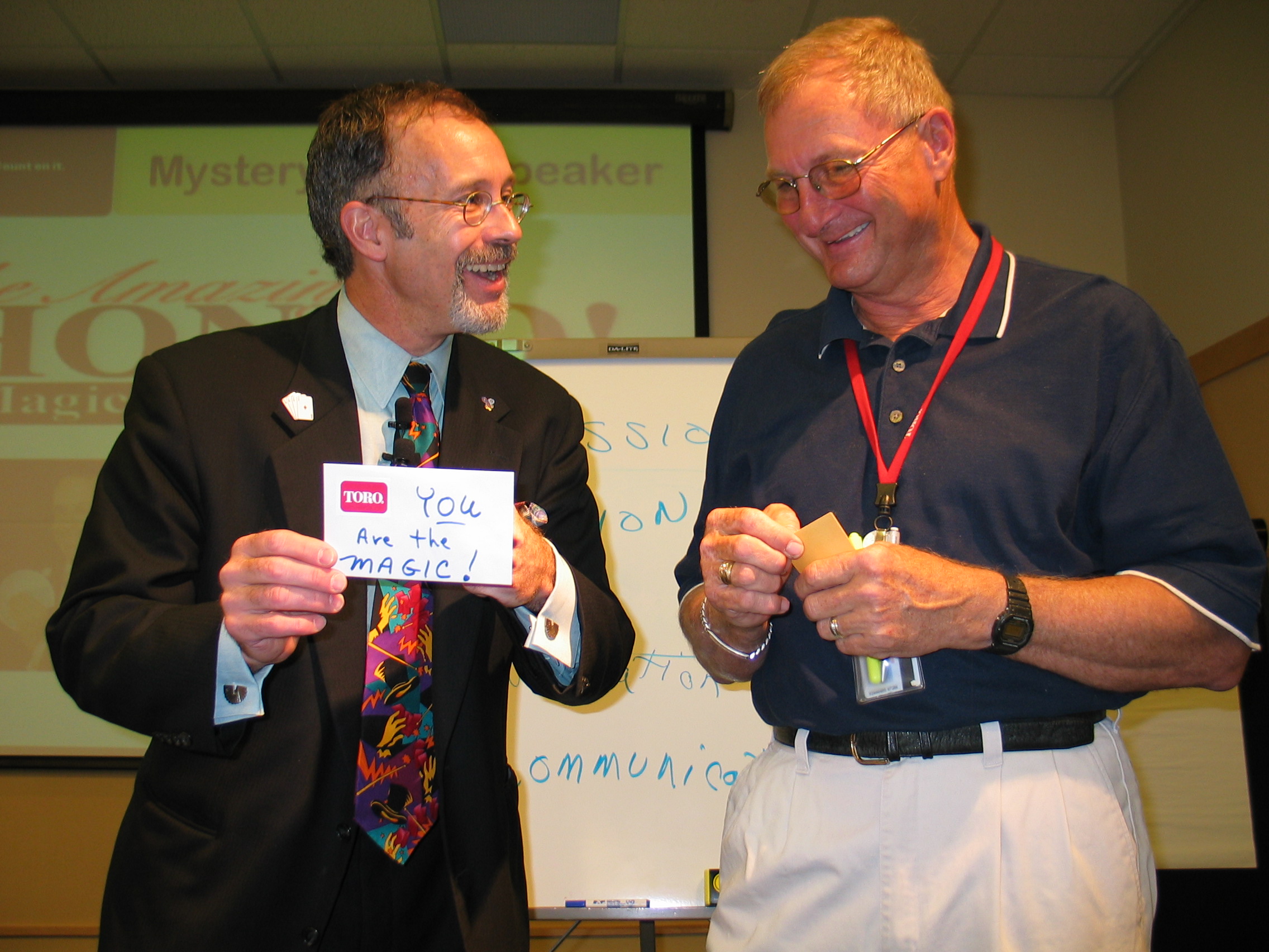 Audience engagement at a Toro management meeting. His assistant's once destroyed $100 bill is about to be found restored in the company envelope. The lesson - Anything's Possible!