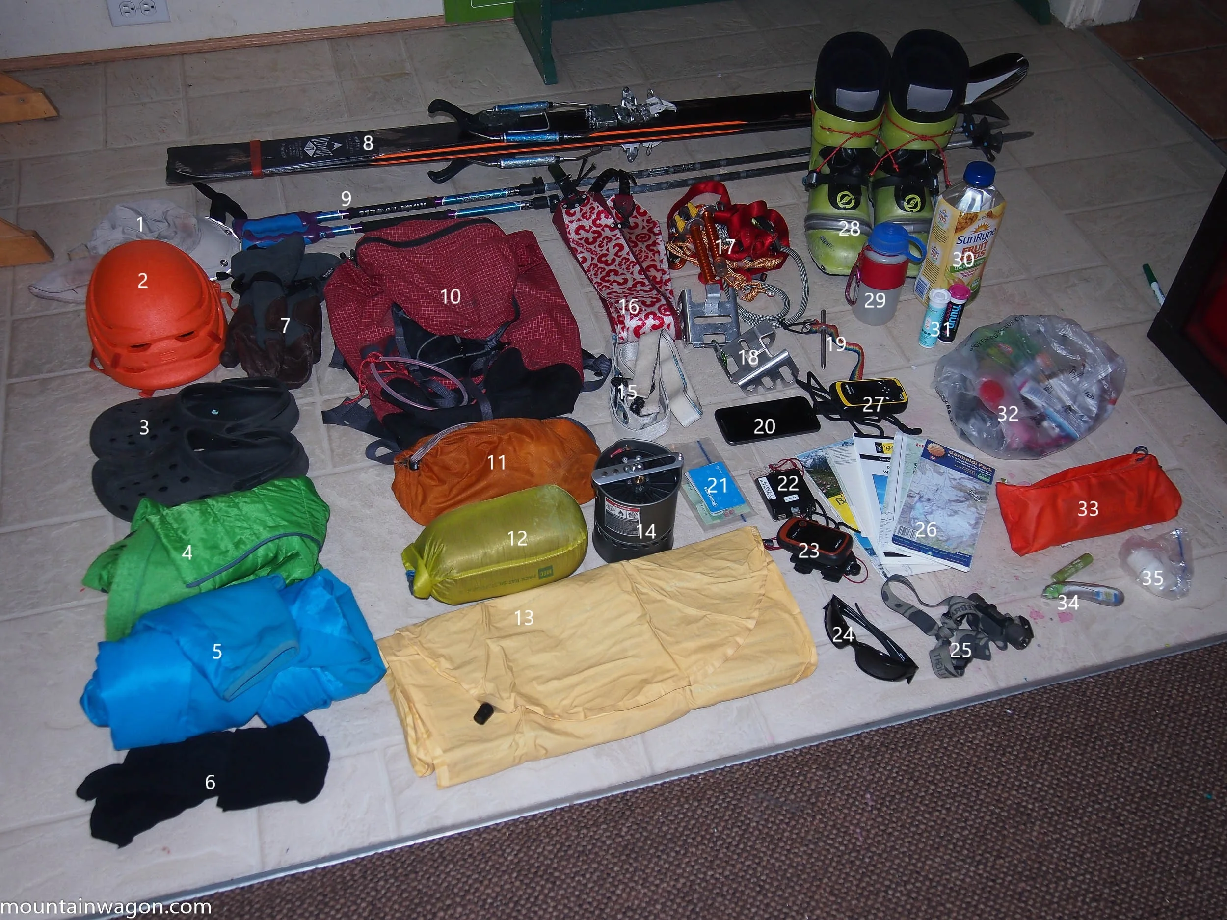 The gear. More than you'd expect. 1. Hat 2. Petzl Sirocco Helmet 3. Crocs 4. 3/4 Length Synthetic Puffy Pants 5. Synthetic Puffy Jacket 6. Spare Socks 7. Gloves 8. Skis with tele-tech bindings 9. Poles 10. MEC Alpine-Lite 35L pack 11. Repair Kit 12. Down Quilt 13. Neo Air X-Lite Sleeping Pad (folded to fit in the pack's back panel slot) 14. MSR Reactor Stove (minus the lid) 15. Skinny Skins 16. Fat Skins 17. Crevasse Self Rescue Kit and Home-Brew Harness 18. Ski Crampons 19. Home-Brew Whippet Ski Pole Attachement 20. Cell Phone 21. 'Wallet' 22. Compass. 23. Garmin e-Trex GPS 24. Sunglasses 25. Zebralight H600 Headlamp 26. Maps 27. inReach 28. Scarpa F1 Boots 29. Water Bottle 30. More Water 31. Nuun Tablets 32. 1.8 Kg Snacks 33. Snack Pouch (attaches to hip belt for refueling on the move) 34. Lip Balm and Tooth Brush 35. Sunscreen.