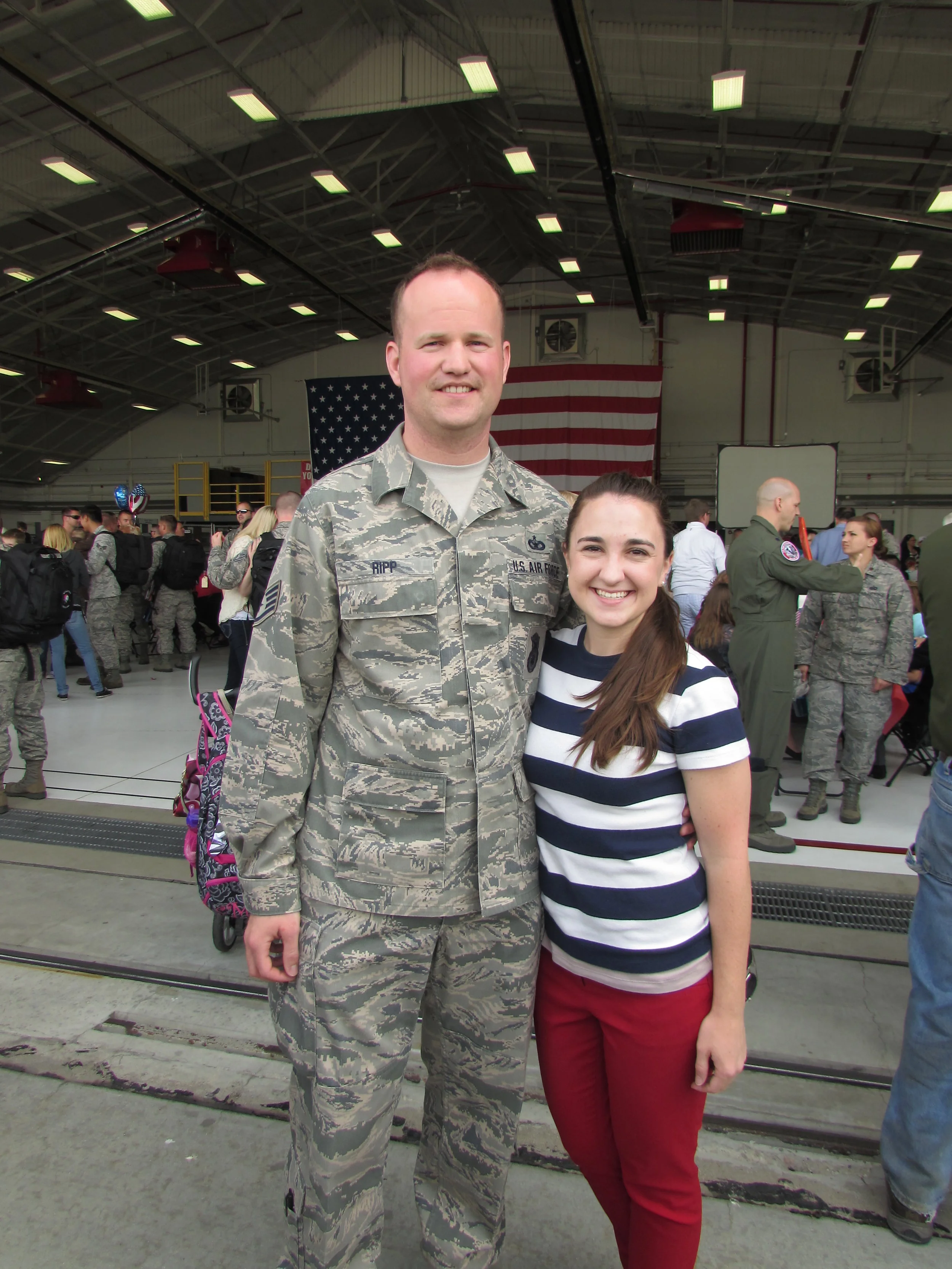 Jenna and now husband, Brandon, at Truax Air Force base in Madison, when they welcomed his brother home from a deployment