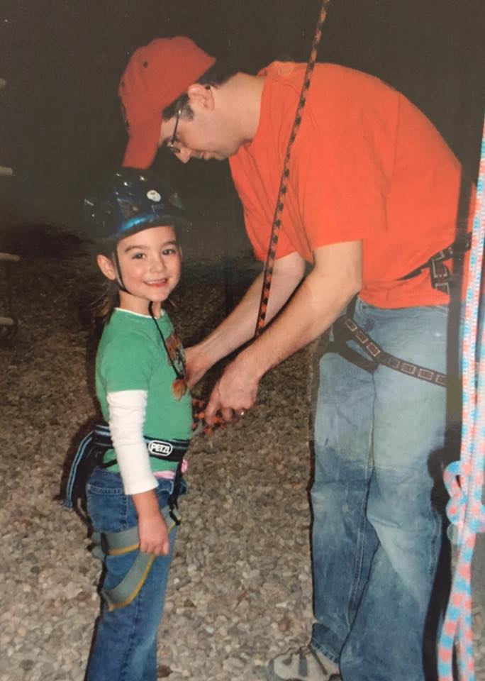 Jr. Team Coach Jim Bell helping a new climber at a birthday party in 2006.