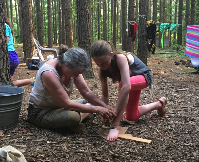Mary Radloff and Lilly Cranking a Bow Drill.png
